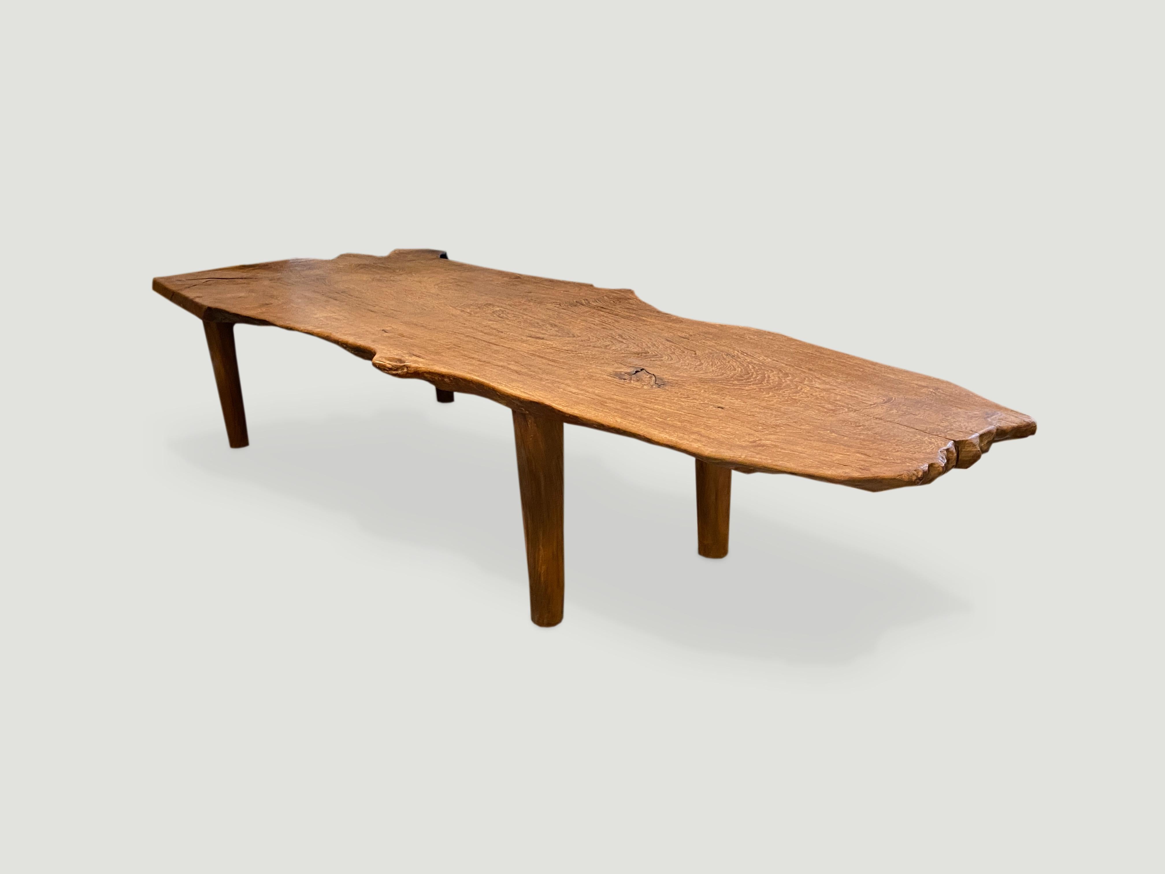Impressive live edge reclaimed teak wood coffee table or bench. Stunning grain on this single slab. We added the midcentury style legs and can increase the height for a console or dining table. We can also charr the wood black if preferred.

This