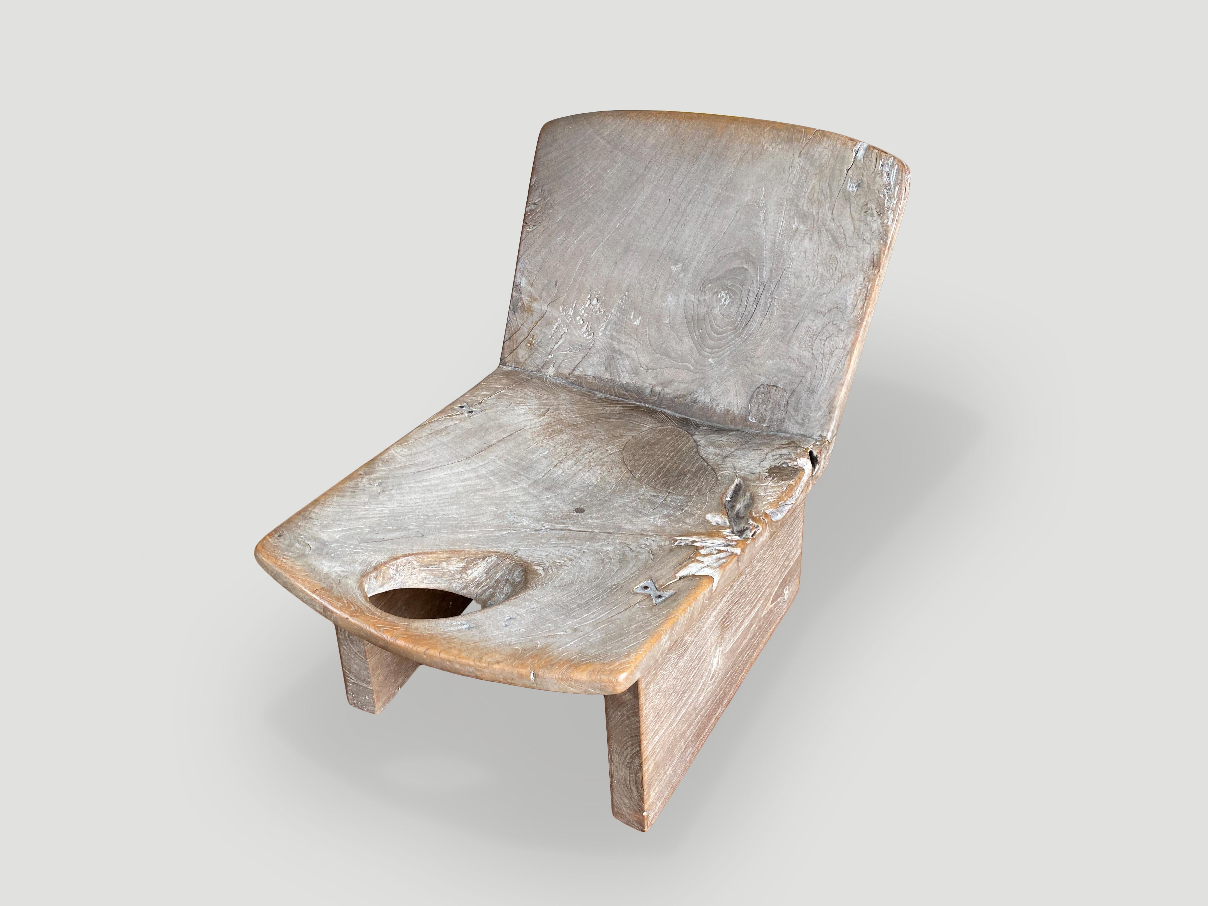 Beautiful teak sourced from my private collection to produce this this low chair that can also be used as a side table. The back rest and seat are hand carved from a single piece of wood. We added minimalist legs and small butterfly details inlaid