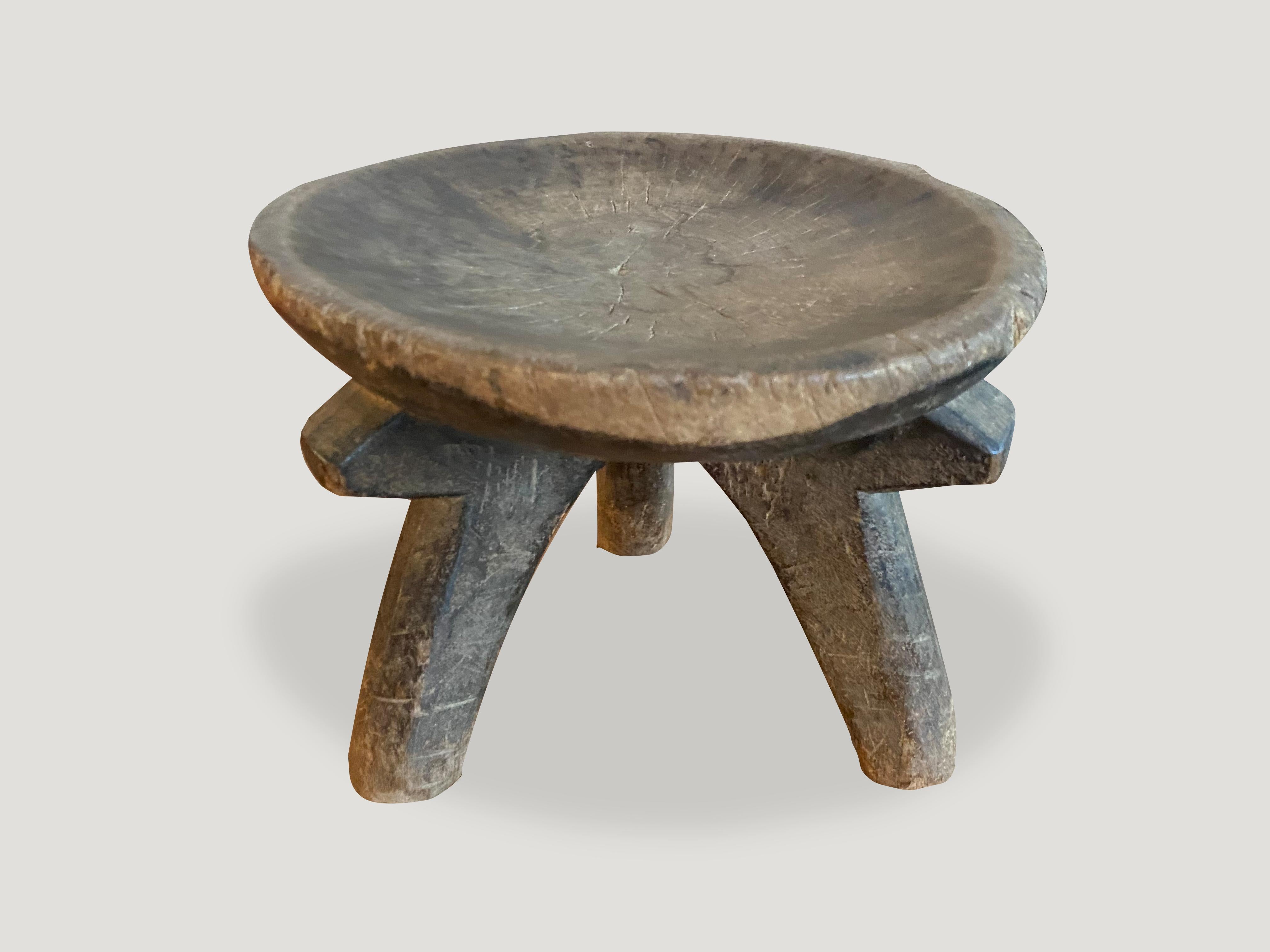 Beautiful hand carved African side table, stool or bowl with lovely patina. Celebrating the cracks and crevices and all the other marks that time and loving use have left behind. The entire piece is hand carved out of a single block of mahogany