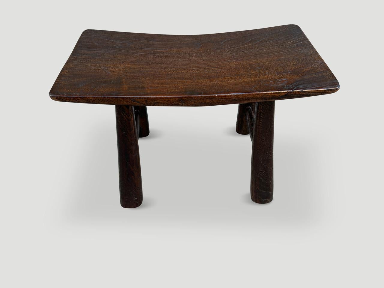 A beautiful antique single teak panel from my finest collection, is expertly shaped into this beautiful bench or stool. Part of the Mid Century Couture Collection. Furniture constructed by hand from start to finish. We added soft rounded mid century