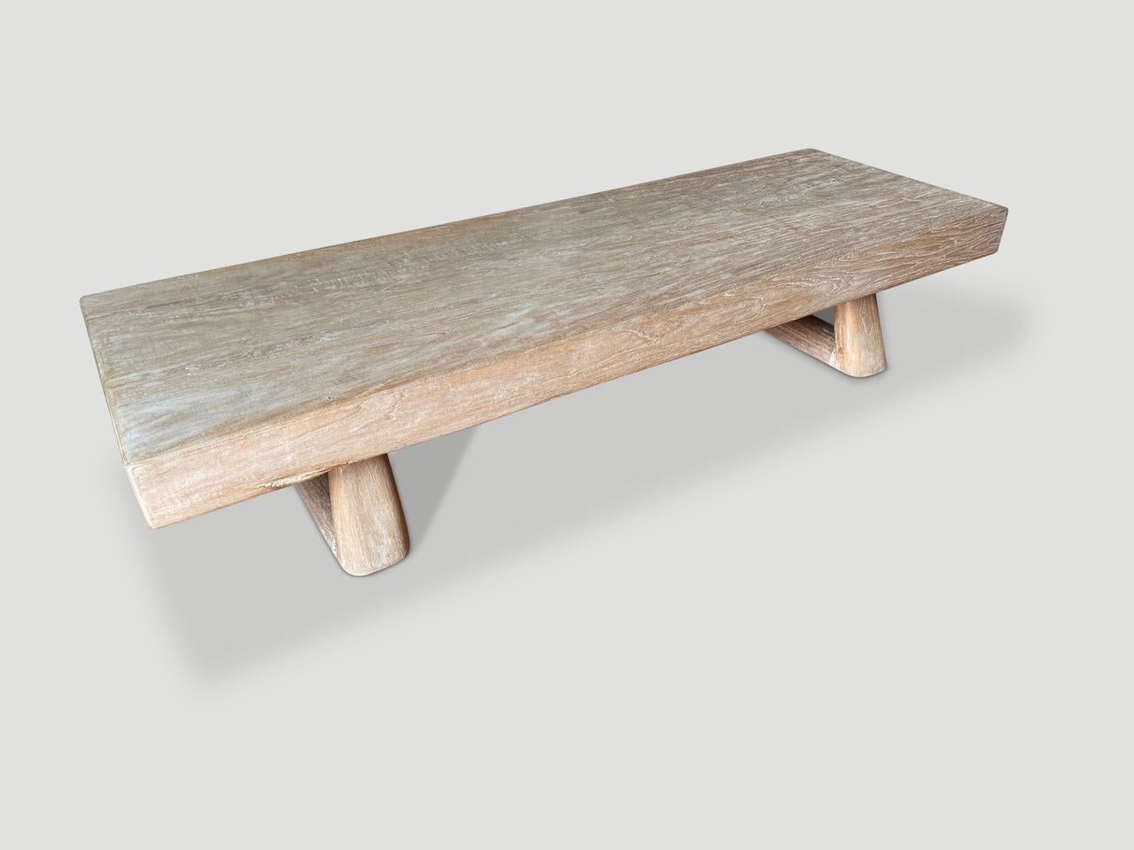 A beautiful century old single teak slab from my private collection, has been hand crafted into a rare coffee table. We added a triangle style base to support this impressive four and a half inch thick top and finished with a translucent milky stain