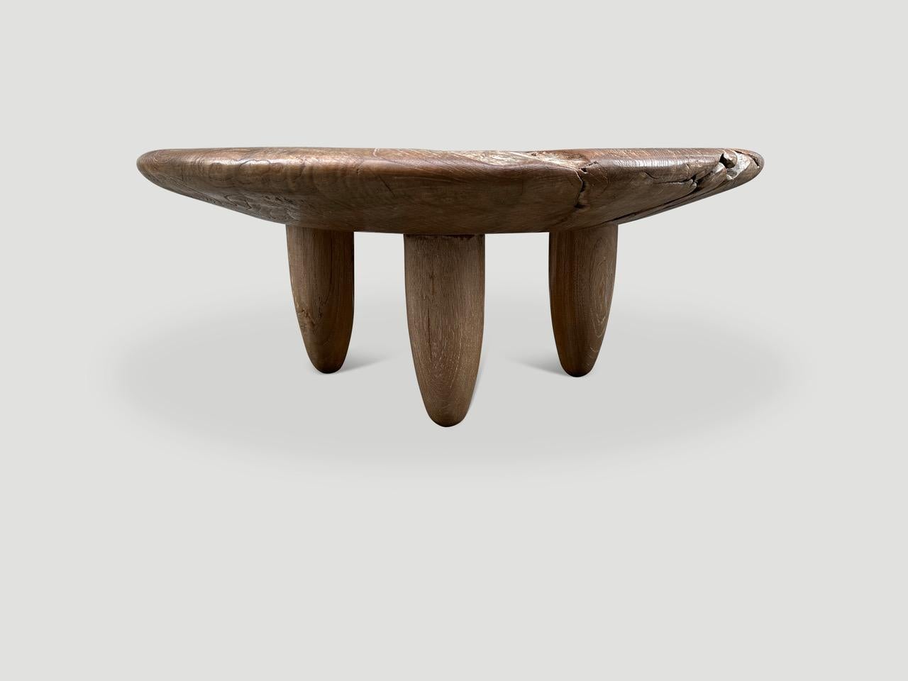 An impressive single slab of teak wood taken from my finest collection is hand carved to produce this one of a kind coffee table with deep bevelled rounded sides. We added four mid century style cone legs and finished the top with a translucent grey