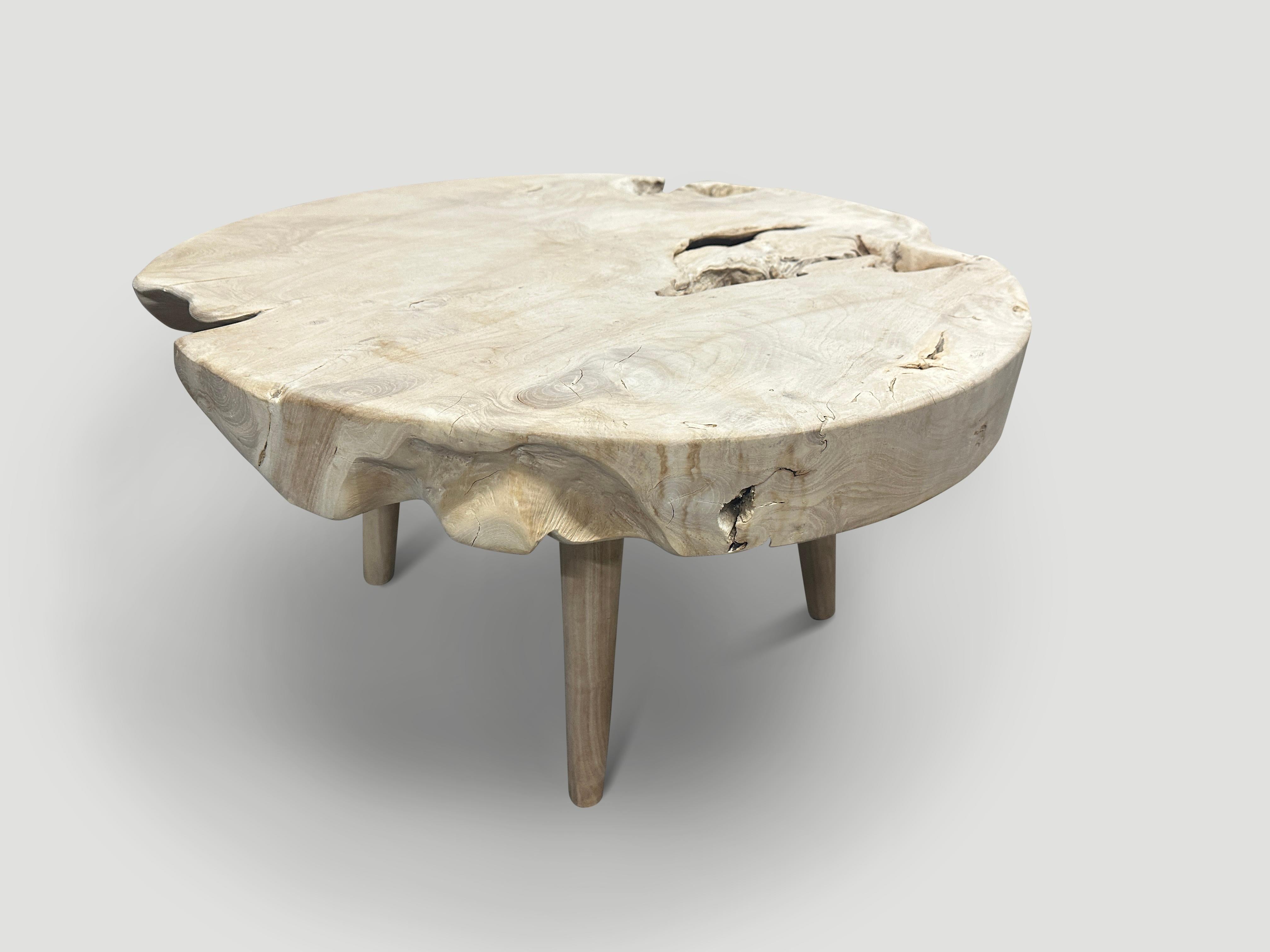 Impressive three inch single slab reclaimed teak wood coffee table. We bleached the teak and added a light white wash revealing the beautiful wood grain. Floating on mid century style legs. Organic with a twist. It’s all in the details. We have a