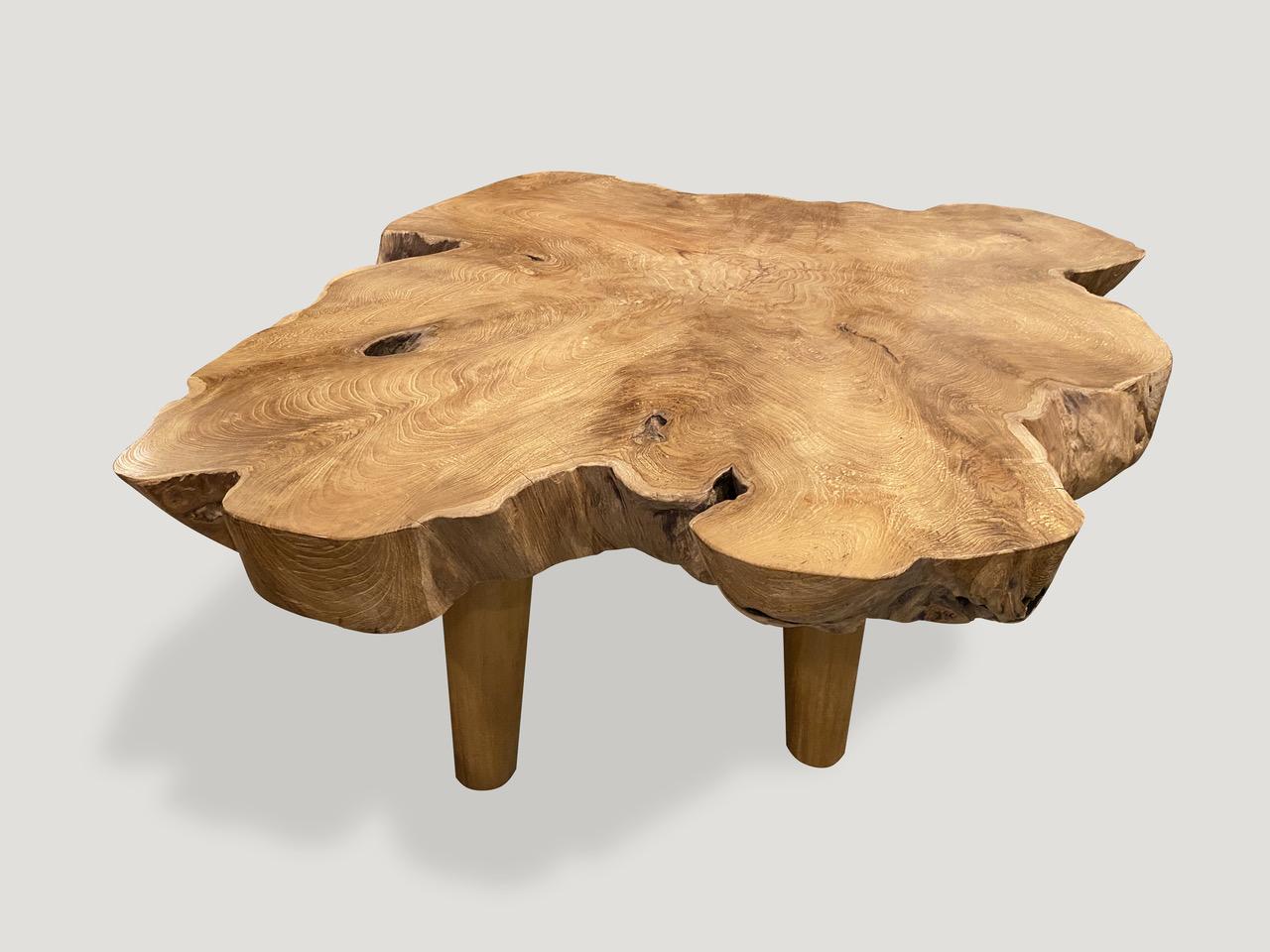 Impresionante tablón de madera de teca de un solo canto vivo de tres pulgadas convertido en mesa de centro sobre patas minimalistas de estilo de mediados de siglo. Acabado con un aceite natural que revela la hermosa veta de la madera. Tenemos una