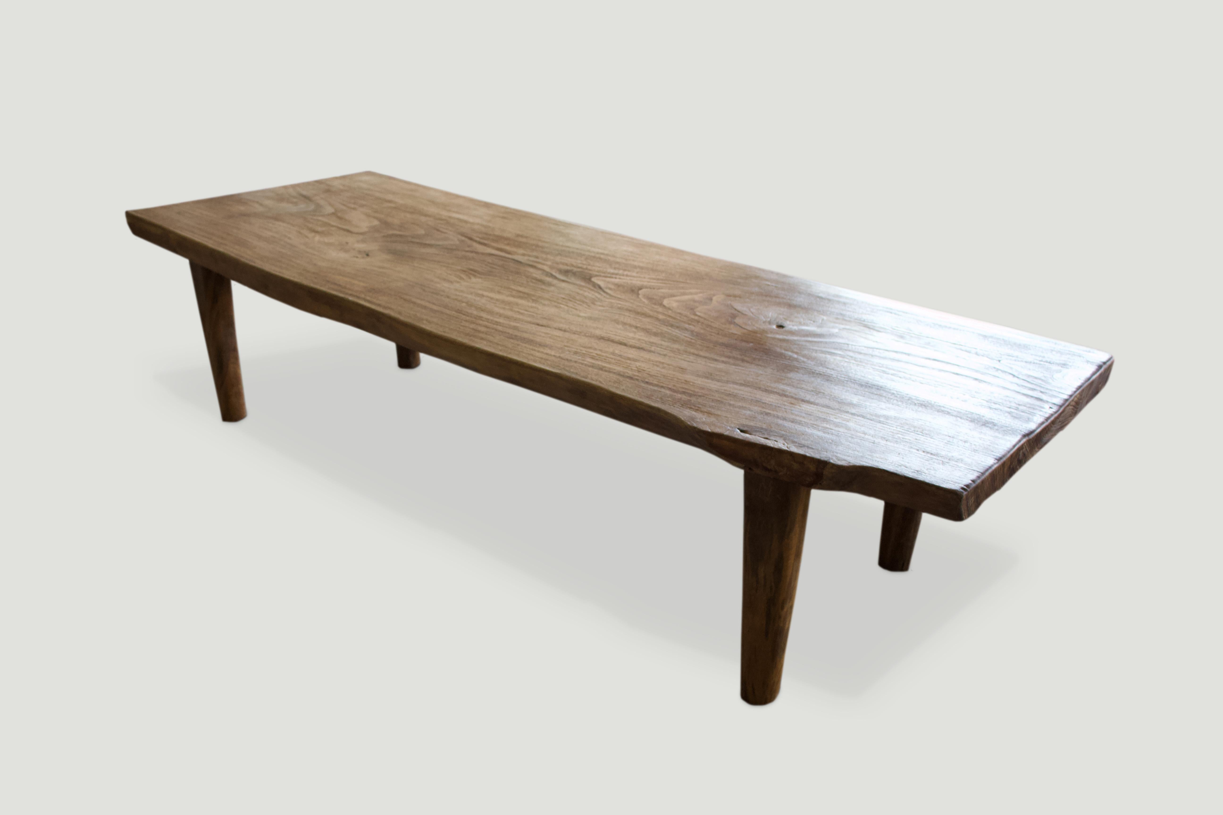 Impressive single slab reclaimed teak coffee table or bench set on mid century style legs. Beautiful grain on this live edge top with a natural oil finish.

Own an Andrianna Shamaris original.

Andrianna Shamaris. The Leader In Modern Organic Design.
