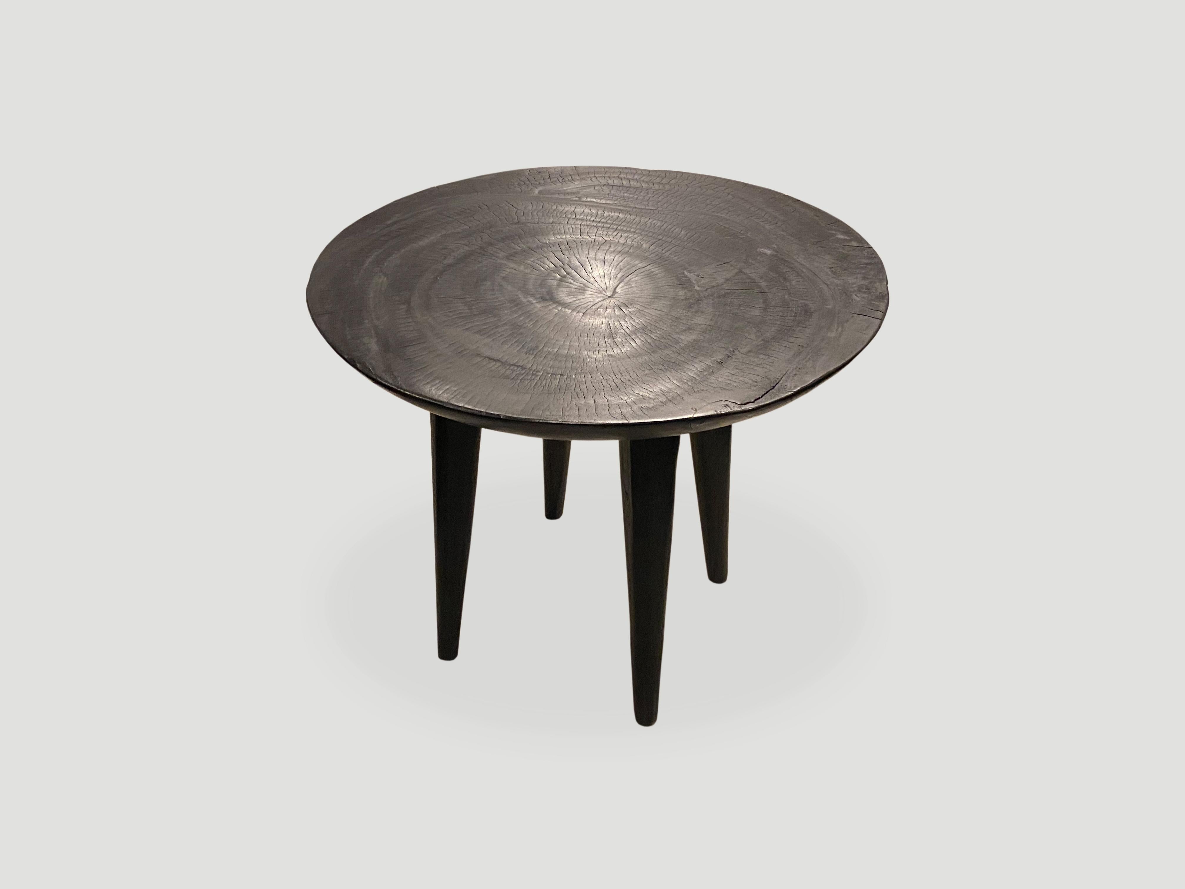 Minimalist charred mango wood side table with a four inch bevelled top resting on cone style legs. Charred, sanded and sealed revealing the beautiful wood grain. Custom stains and finishes available. Please inquire.

Own an Andrianna Shamaris