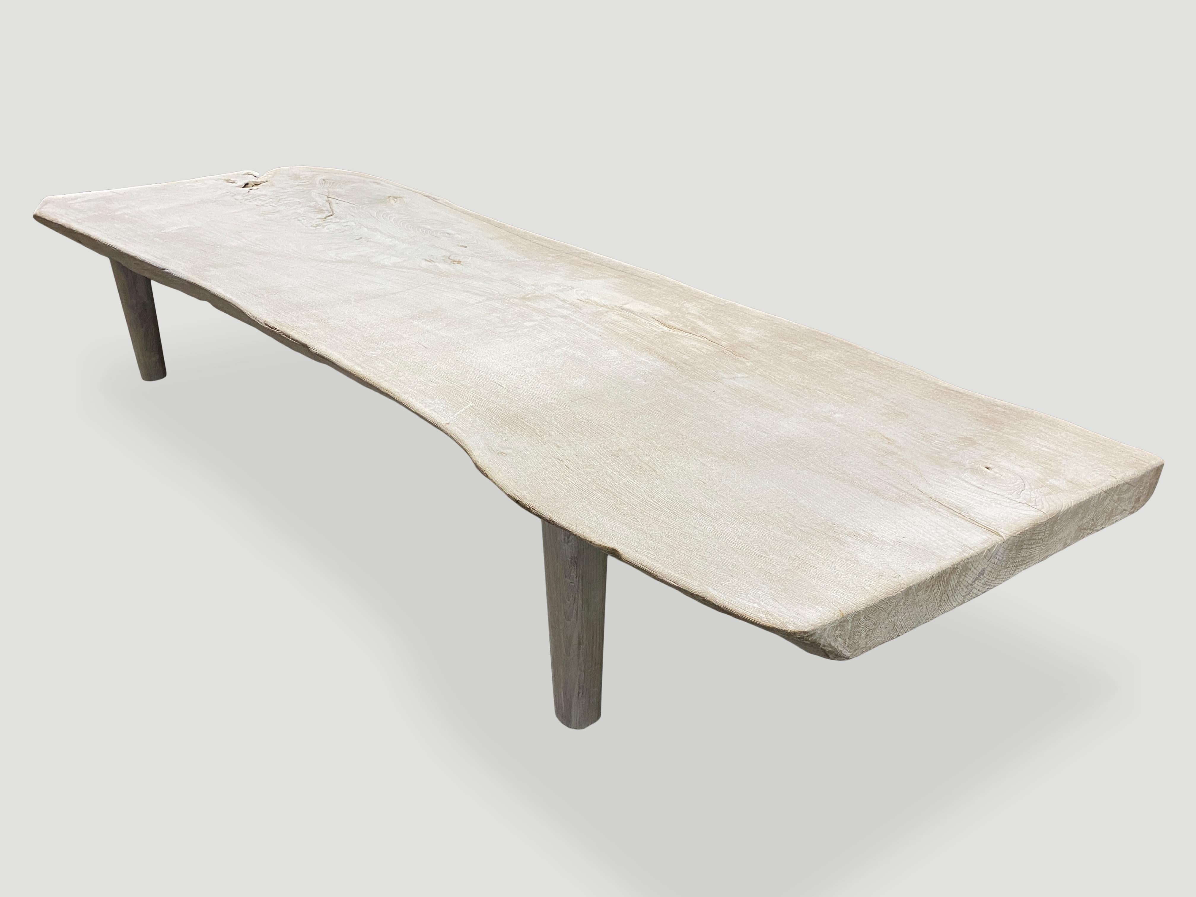 Impressive single slab, live edge bleached teak coffee table or bench with natural erosion. We have added a light white wash finish revealing the beautiful grain on this reclaimed two and a half inch teak slab. Finally we added minimalist legs.