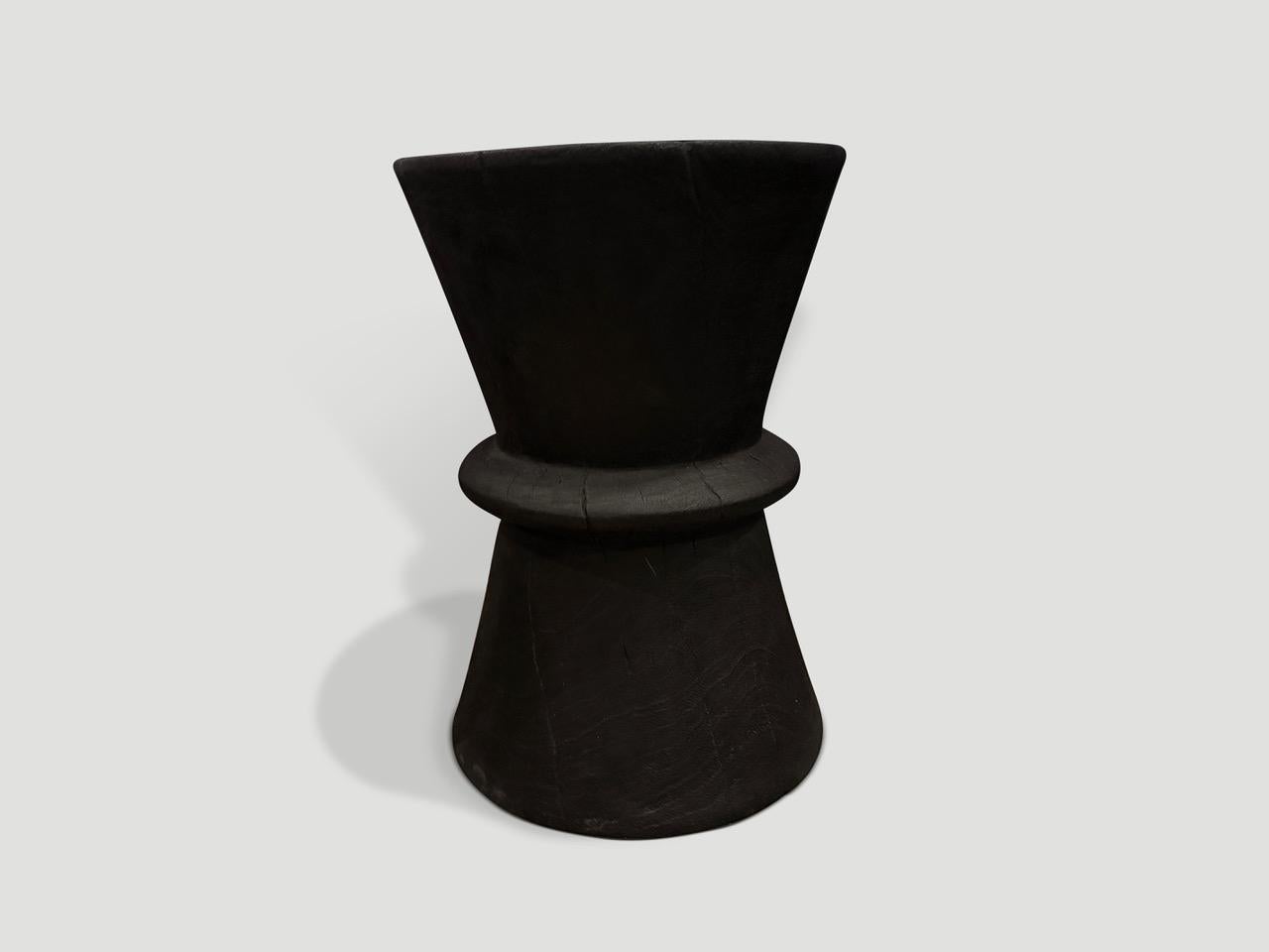 Beautiful minimalist hand carved reclaimed suar wood side table. Charred, sanded and sealed revealing the unique wood grain. We have a small collection. The price and images reflect one.

The Triple Burnt Collection represents a unique line of