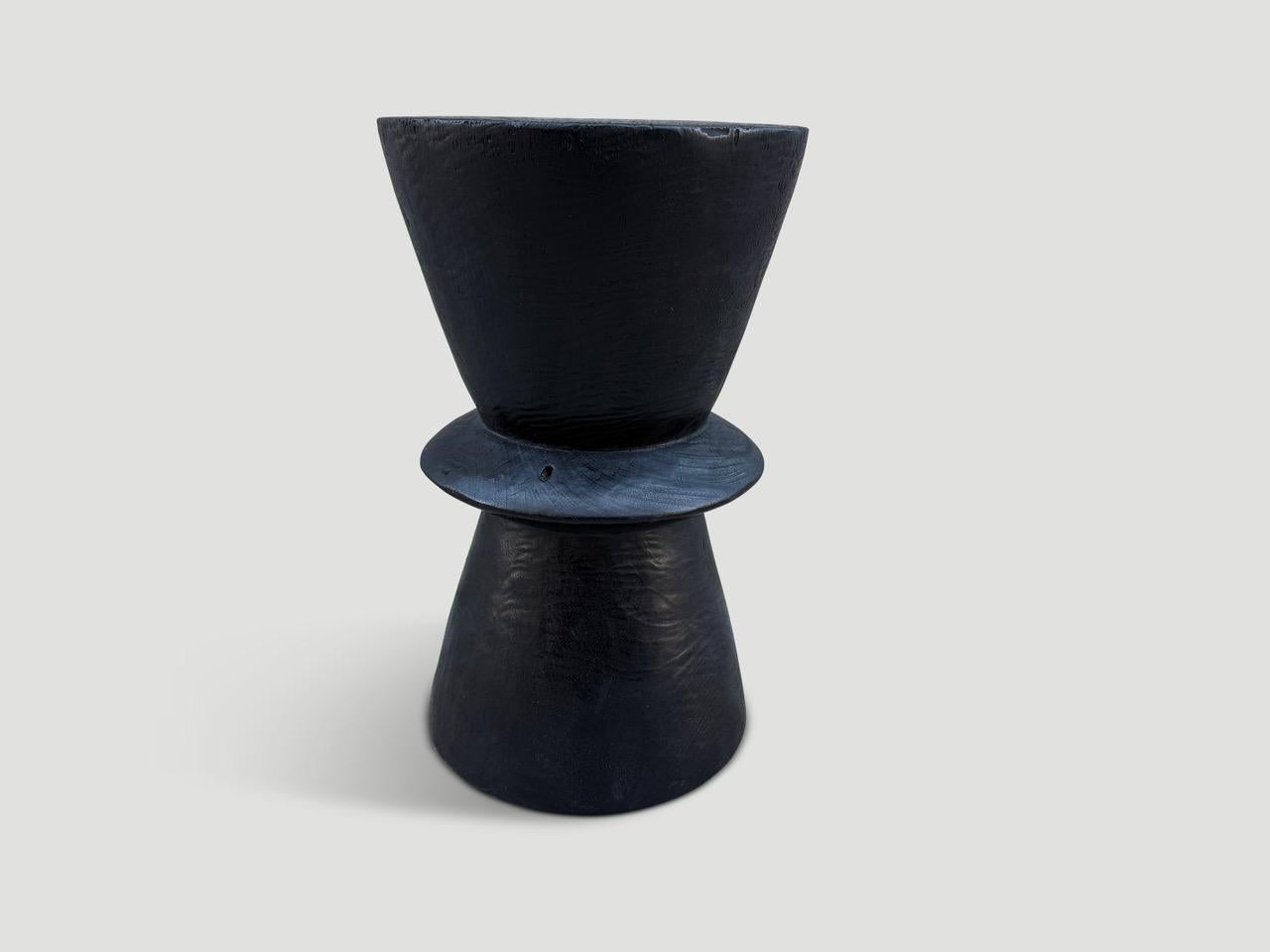 Beautiful minimalist hand carved reclaimed suar wood side table. Charred, sanded and sealed revealing the unique wood grain. We have a small collection. The price and images reflect one.

The Triple Burnt Collection represents a unique line of