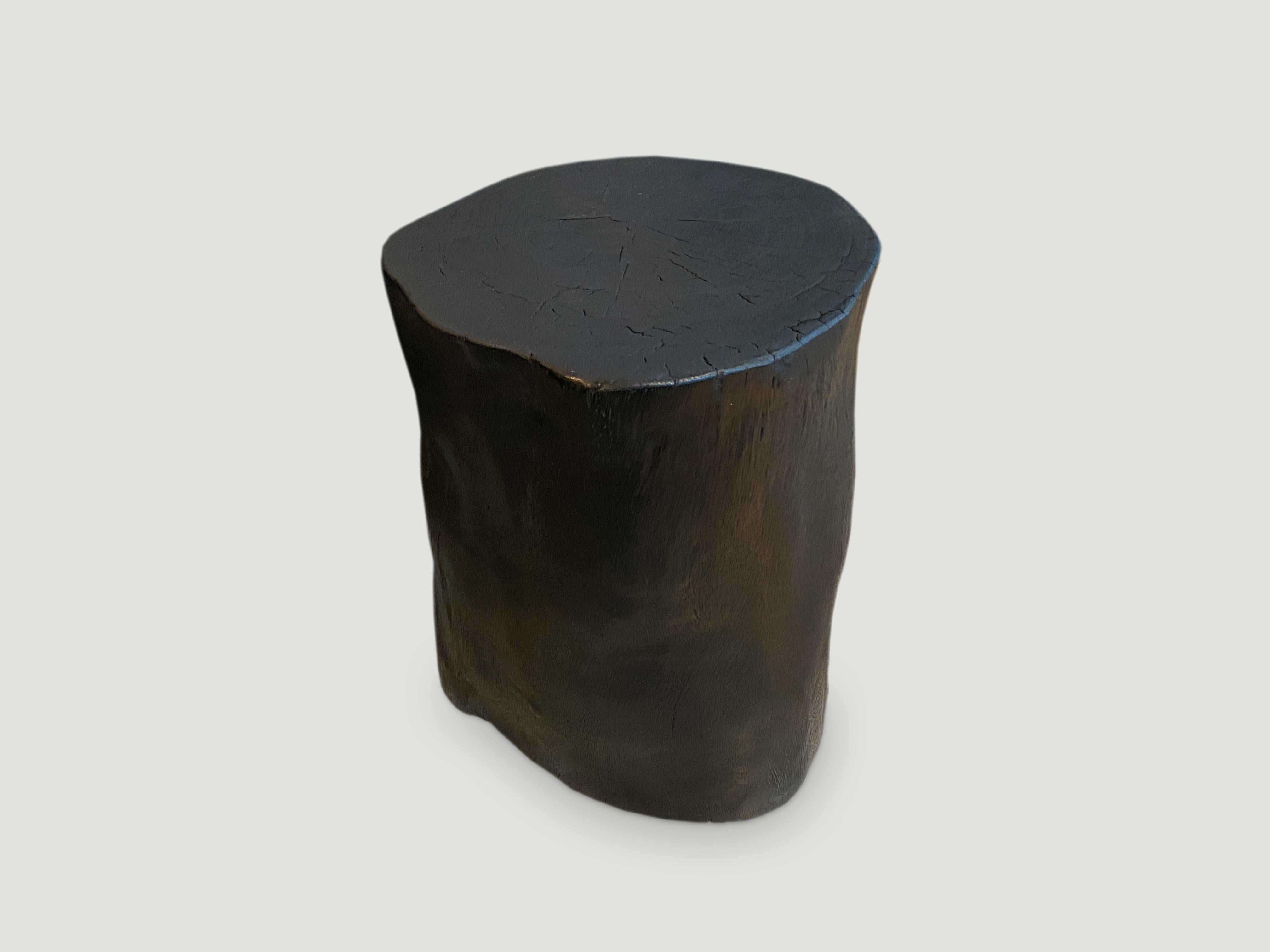 Minimalist hand carved solid reclaimed suar wood side table. Burnt, sanded and sealed whilst respecting the natural organic shape. We have a collection. All unique. The price and size reflects the one shown.

The Triple Burnt collection represents