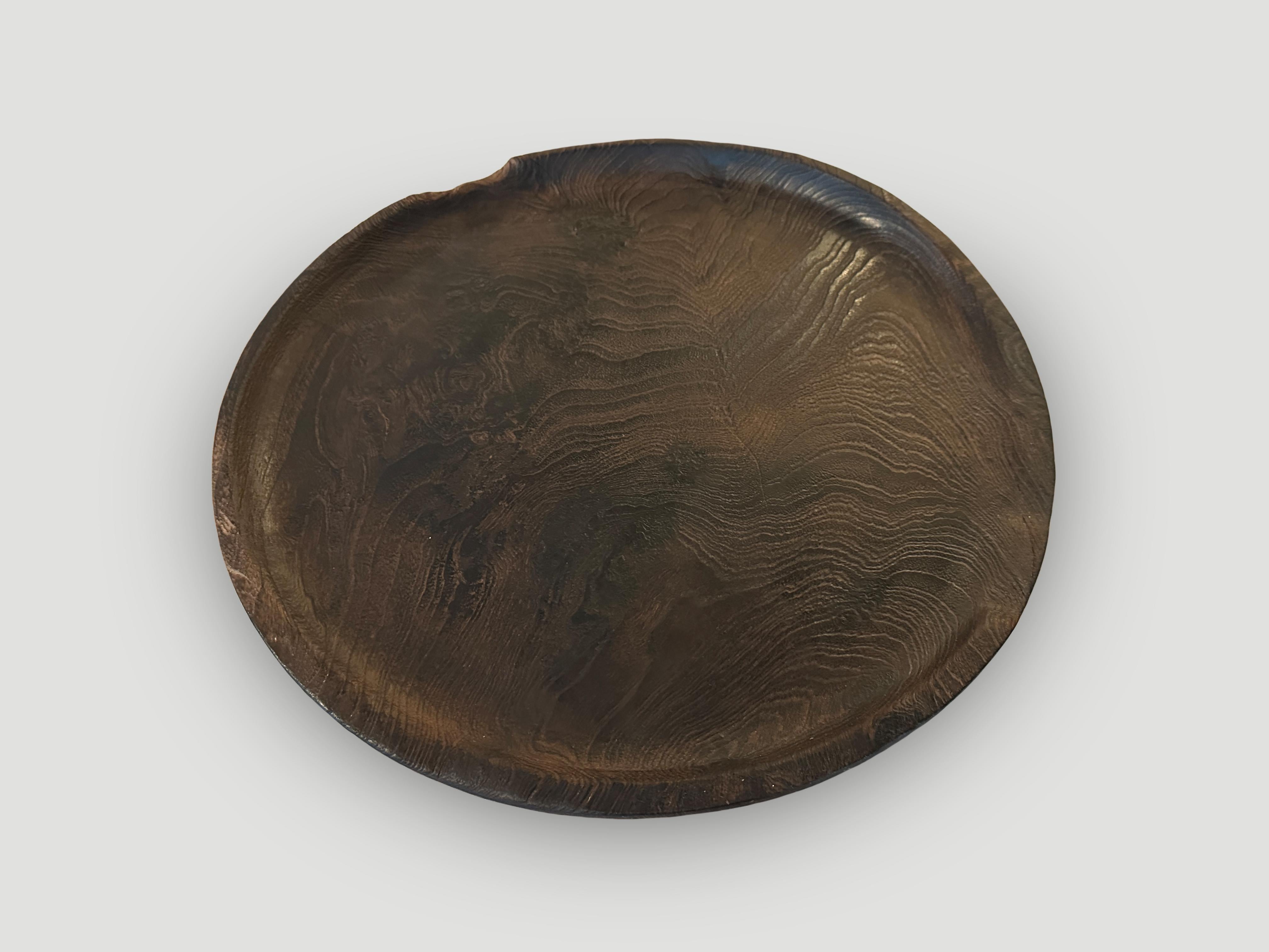 Beautiful wood grain in this minimalist shallow platter. This platter was hand made from a single piece of teak wood in the spirit of Wabi-Sabi, a Japanese philosophy that beauty can be found in imperfection and impermanence. It is a beauty of