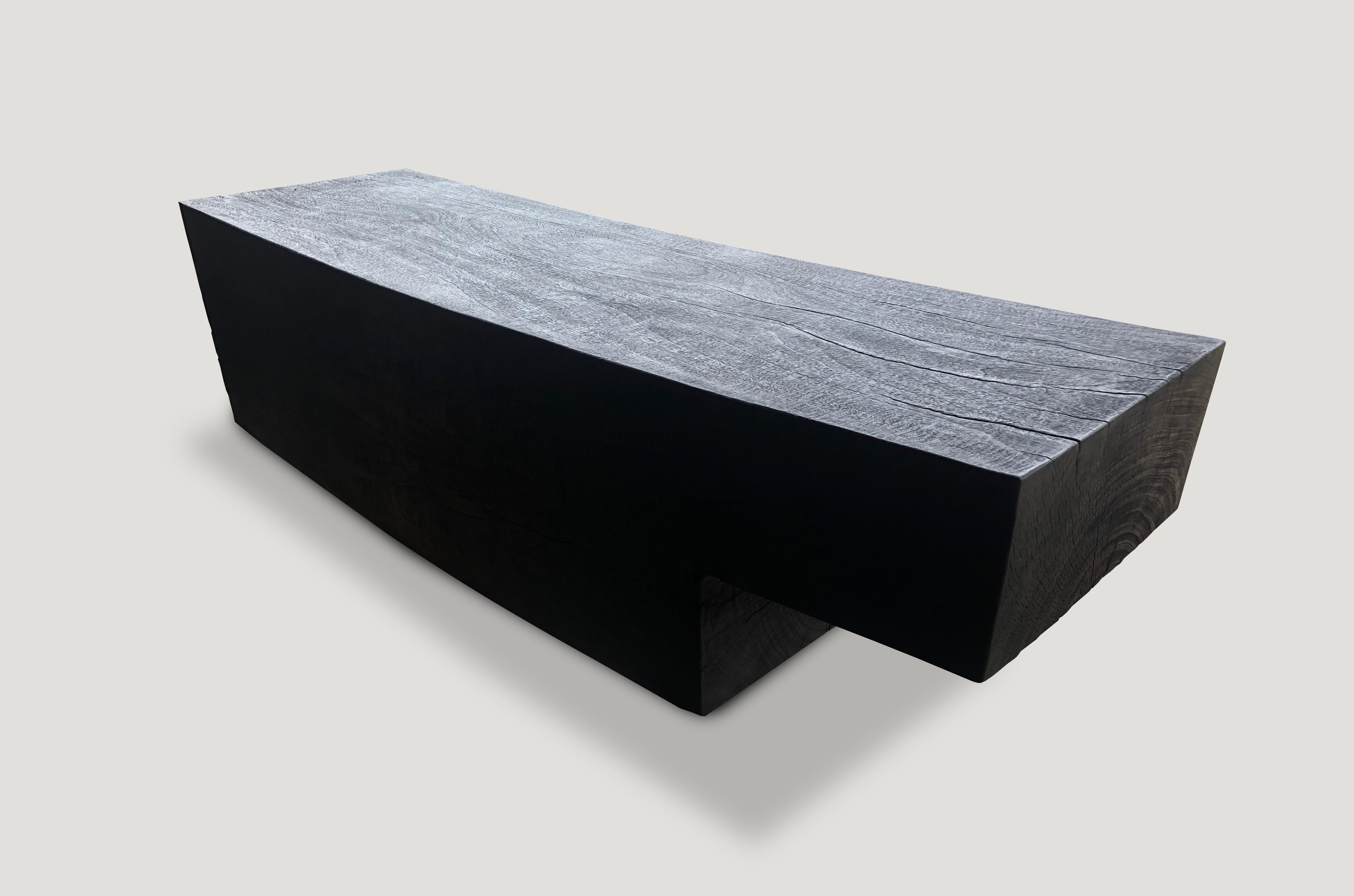 Impressive minimalist charred suar wood log bench with a smooth satin finish. Charred, sanded and sealed revealing the beautiful wood grain. Custom finishes and sizes available. Please inquire.  

The Triple Burnt Collection represents a unique line