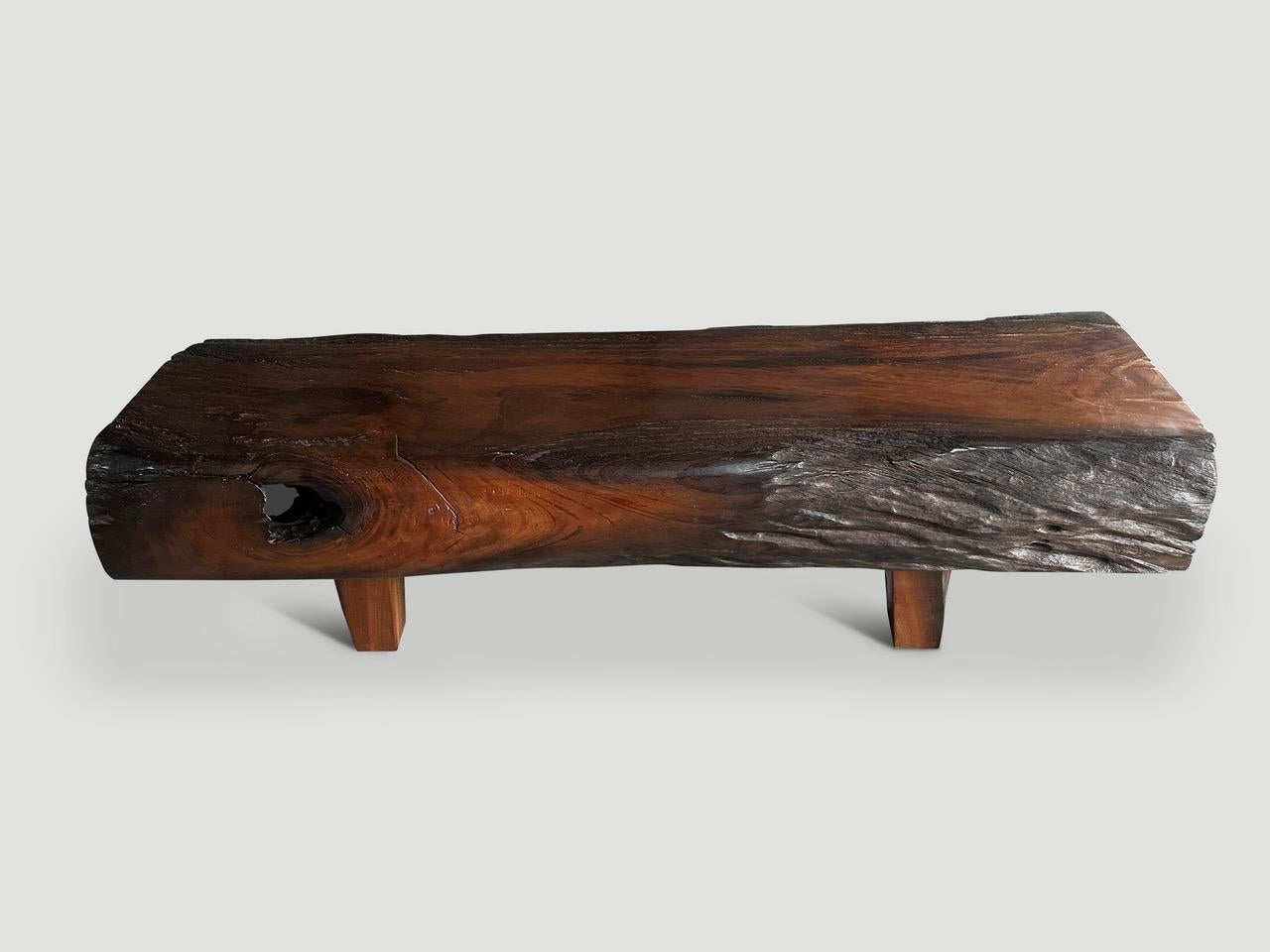 Impressive eight inch thick teak log sanded and partially charred to create a striking visual contrast. We added minimalist legs and wood butterflies on the end. Finished with a natural oil revealing the beautiful wood grain. It’s all in the