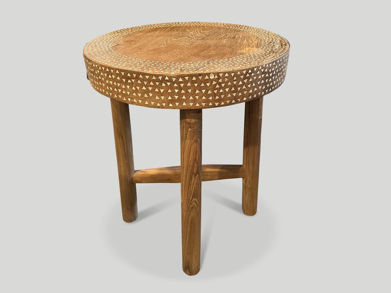 Beautiful shell inlaid side table or pedestal hand made from reclaimed teak wood. Each piece of white shell is carefully hand cut and applied to create this stunning table with a 3.5” thick top. We added a minimalist cross base. It’s all in the