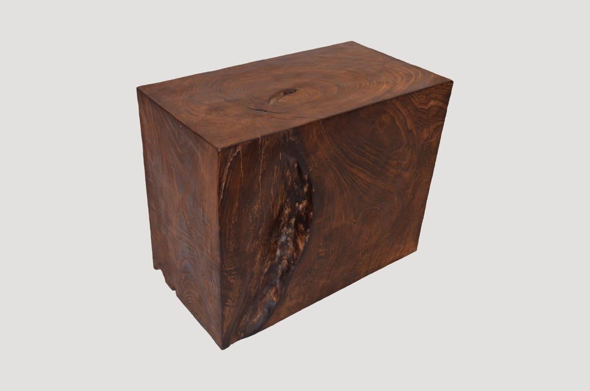 Minimalist side table hand carved whilst respecting the natural reclaimed teak wood. Single charred revealing the beautiful wood grain. 

The Triple Burnt Collection represents a unique line of modern furniture made from solid organic wood. Burnt