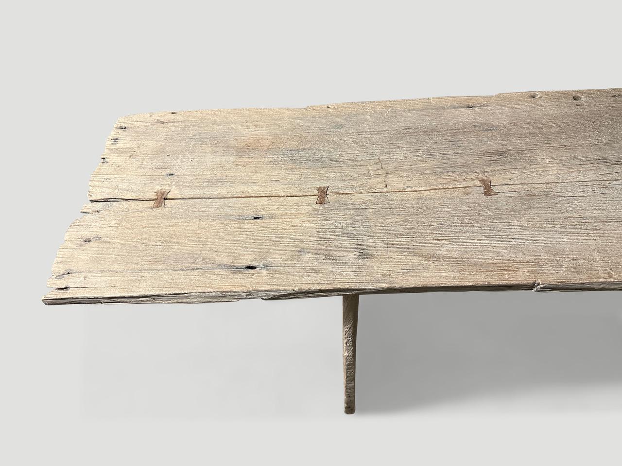 Impressive single slab live edge bleached teak console table with butterfly detail. We added our white wash secret ingredient revealing the beautiful grain on this reclaimed teak wood. The top rests on minimalist teak panels. It’s all in the