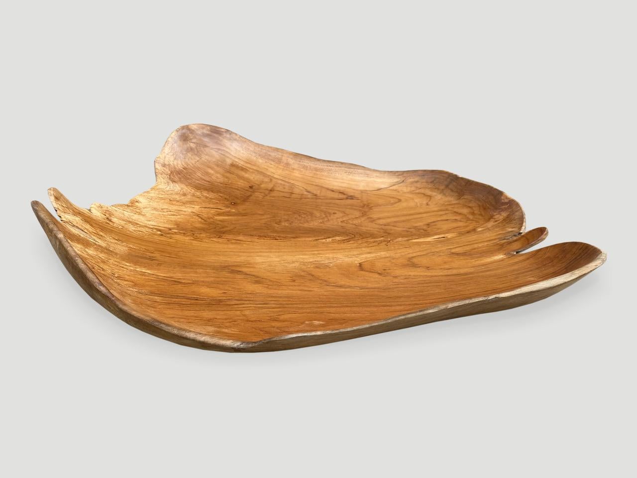 Beautiful grain on this minimalist teak bowl, hand carved from a single piece of reclaimed teak wood.

This bowl or tray was sourced in the spirit of wabi-sabi, a Japanese philosophy that beauty can be found in imperfection and impermanence. It is