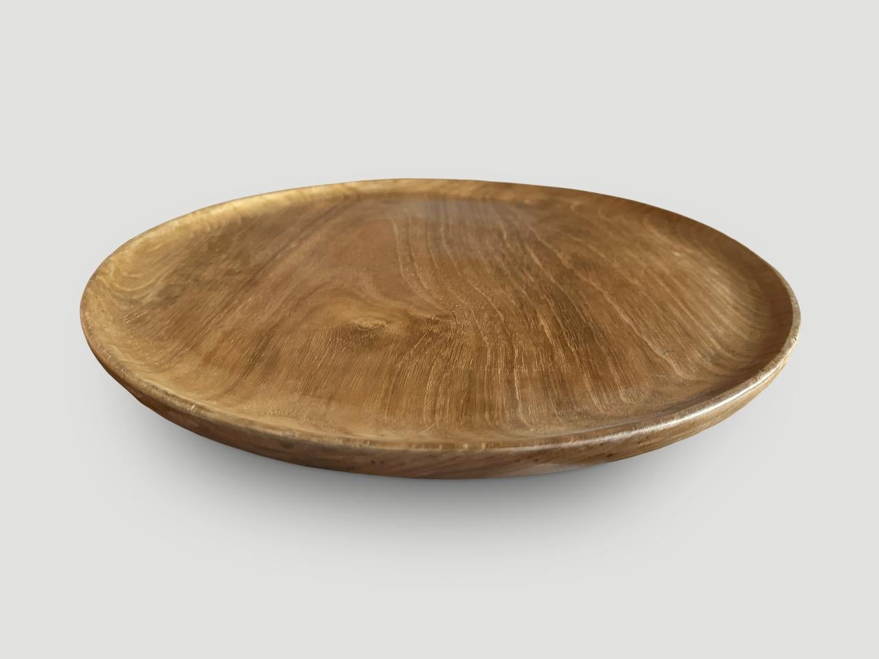 Beautiful wood grain in this minimalist shallow platter. This platter was hand made from a single piece of reclaimed teak wood in the spirit of Wabi-Sabi, a Japanese philosophy that beauty can be found in imperfection and impermanence. It is a