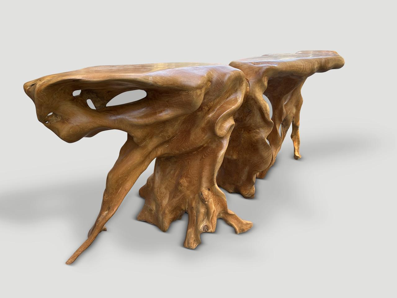 Impressive one of a kind sculptural console made from a beautiful old teak root. Fabulous in a residence or hotel lobby. Both usable and a piece of art. Finished with a natural oil revealing the unique wood grain.

Own an Andrianna Shamaris