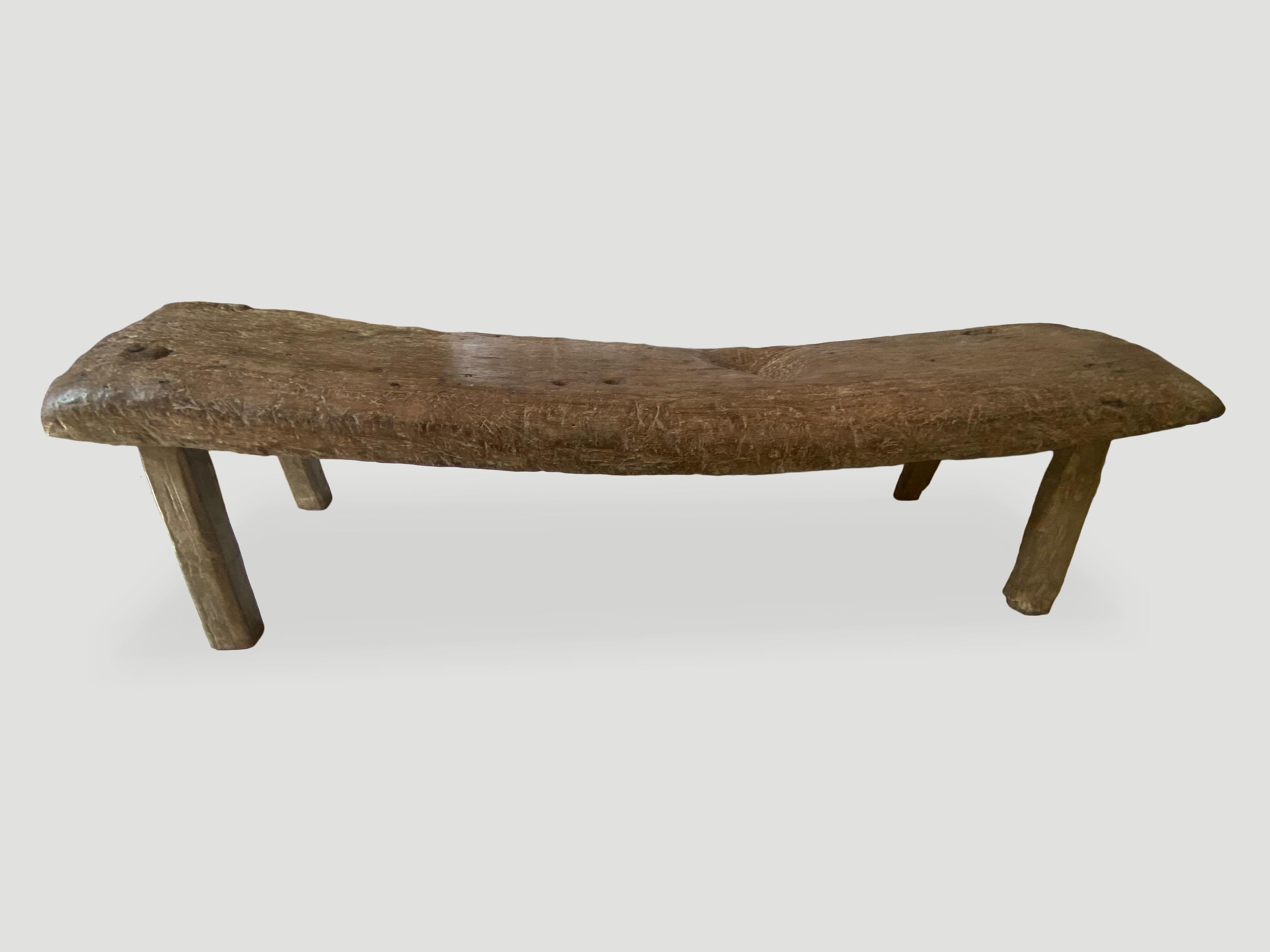 For the collector. This stunning three inch thick teak slab bench has been hand carved from the island Madura. Beautiful soft rounded edges and beautiful markings on this century old bench. Rare.

This bench was sourced in the spirit of wabi-sabi, a