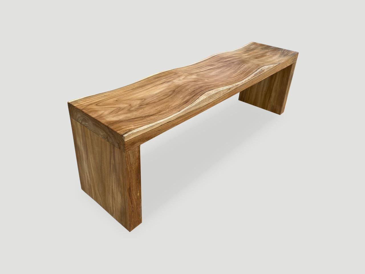 The teak wood wave bench represents a sleek, modern aesthetic, designed to provide comfort and durability. A solid single slab of reclaimed teak wood is hand carved into a wave design, sanded and sealed with a natural oil finish. Our modern wave