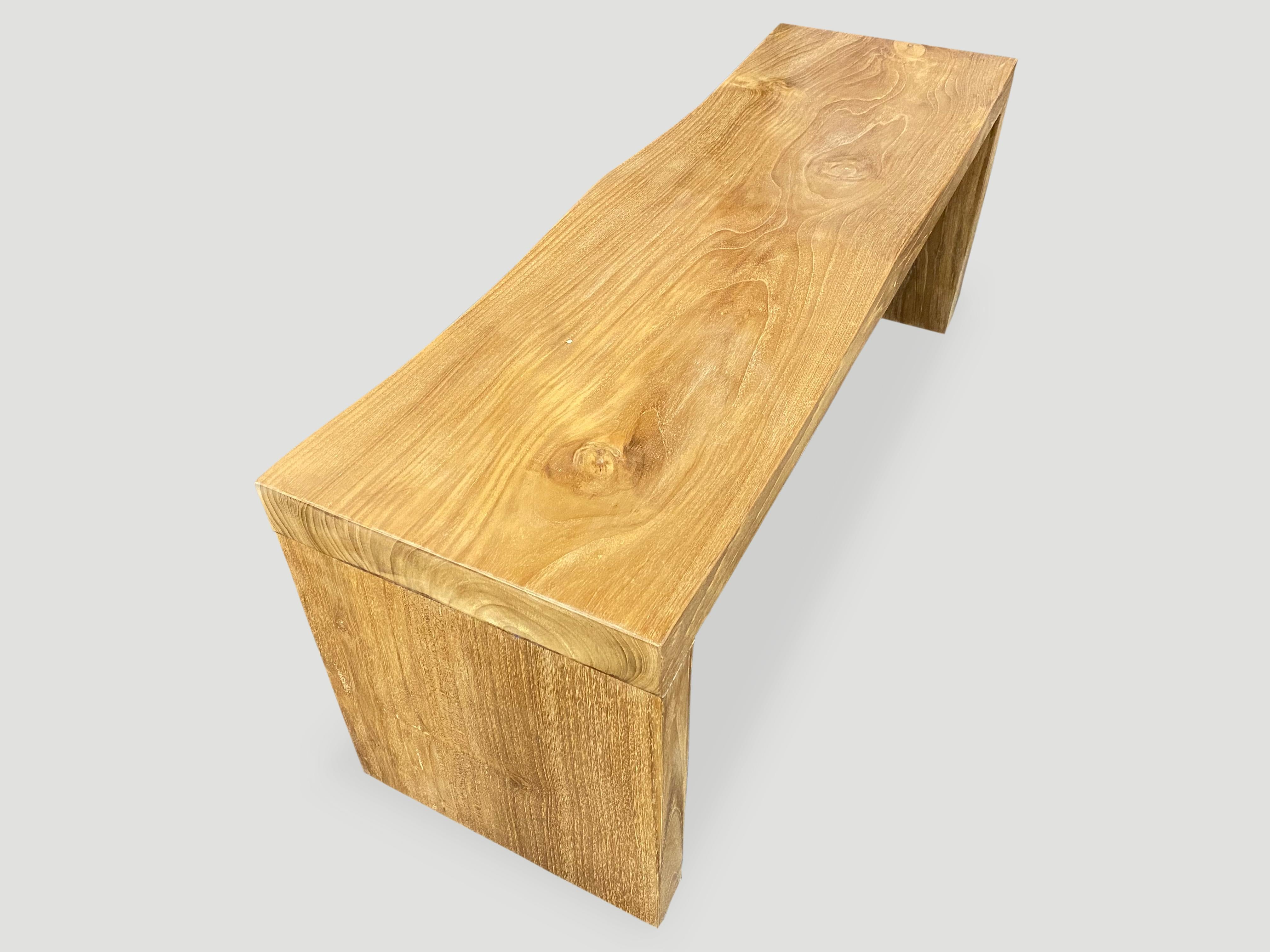 The teak wave bench represents a sleek, modern aesthetic, designed to provide comfort and durability. A solid single slab of reclaimed teak wood is hand carved into a wave design, sanded and sealed with a natural oil finish. Our modern wave bench