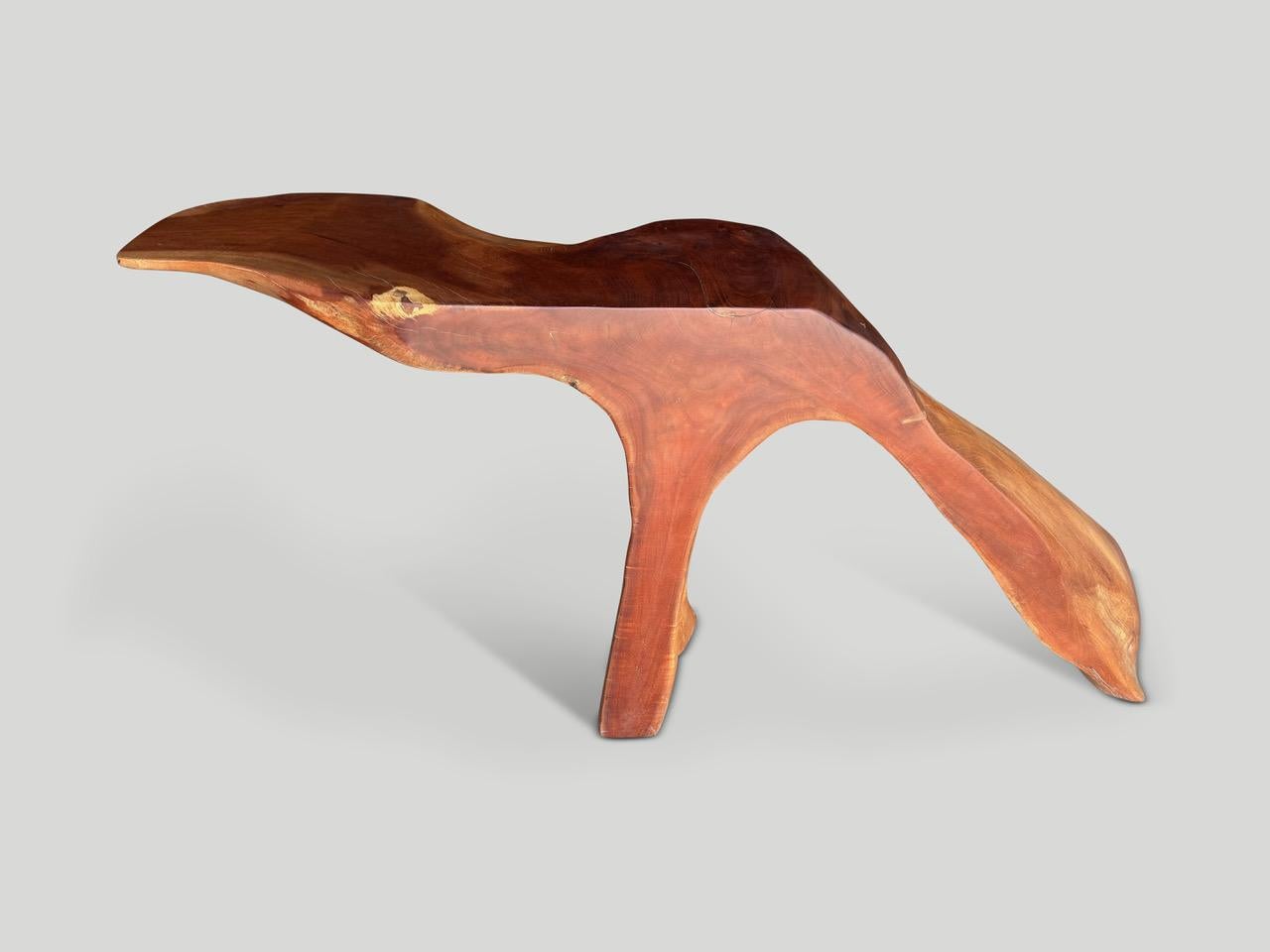 Beautiful reclaimed mahogany wood hand carved sculpture or console table. An impressive piece for any room. Both usable and sculptural. Finished with a natural oil revealing the unique wood grain. It’s all in the details. Full dimensions; Top 35”