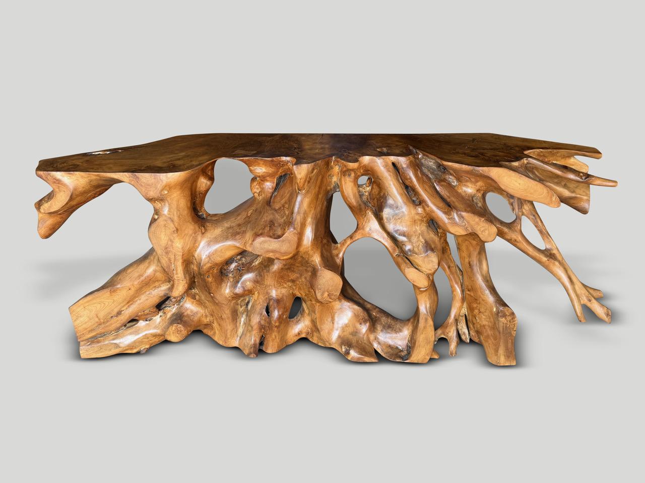 Impressive one of a kind sculptural console made from a beautiful century old teak root. Fabulous on both sides. Finished with a natural oil revealing the unique wood grain. It’s all in the details.

Own an Andrianna Shamaris original.

Andrianna
