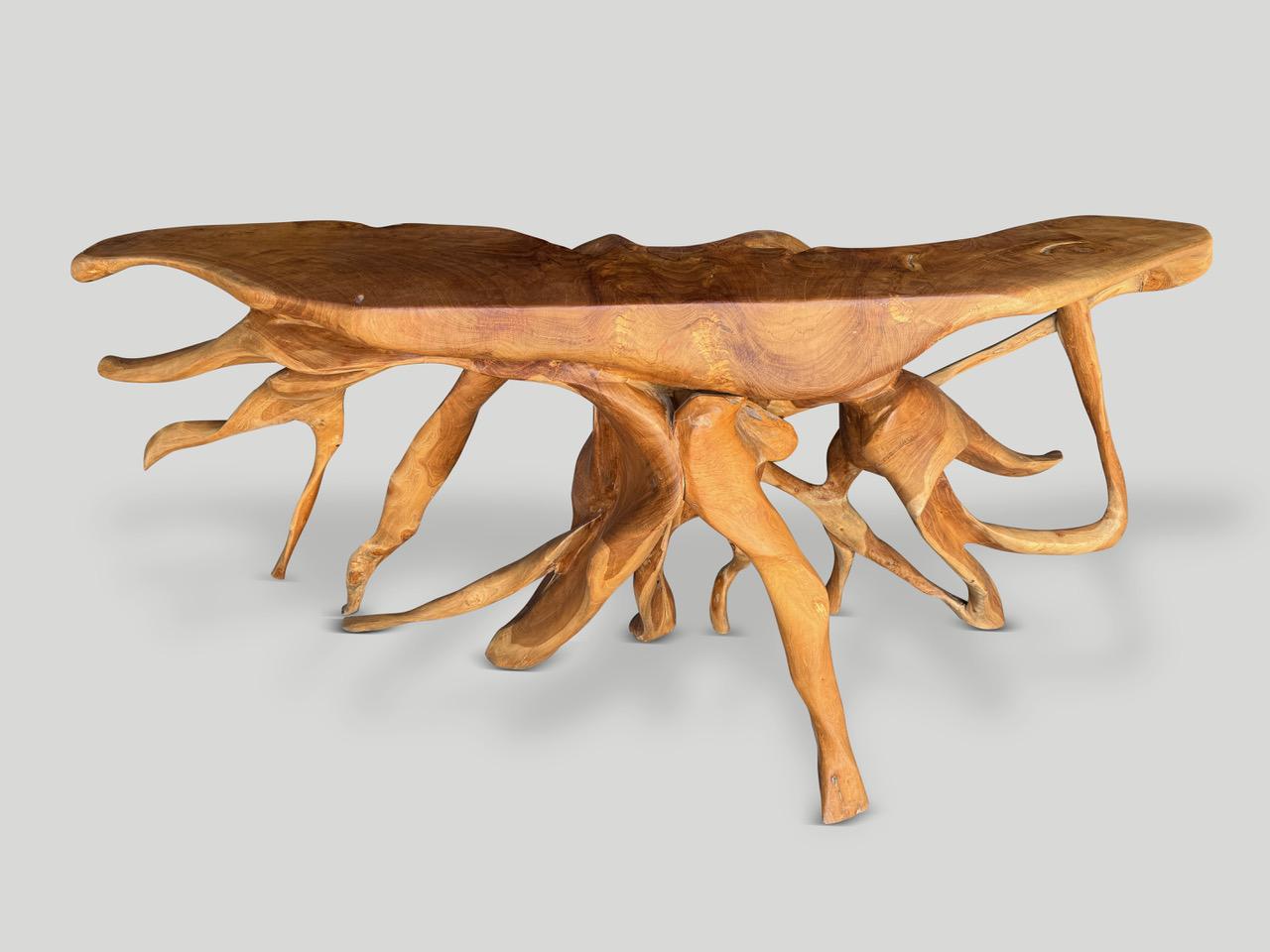 Impressive one of a kind sculptural console table made from a beautiful century old teak root. Fabulous on both sides. Finished with a natural oil revealing the unique wood grain. It’s all in the details.

Own an Andrianna Shamaris