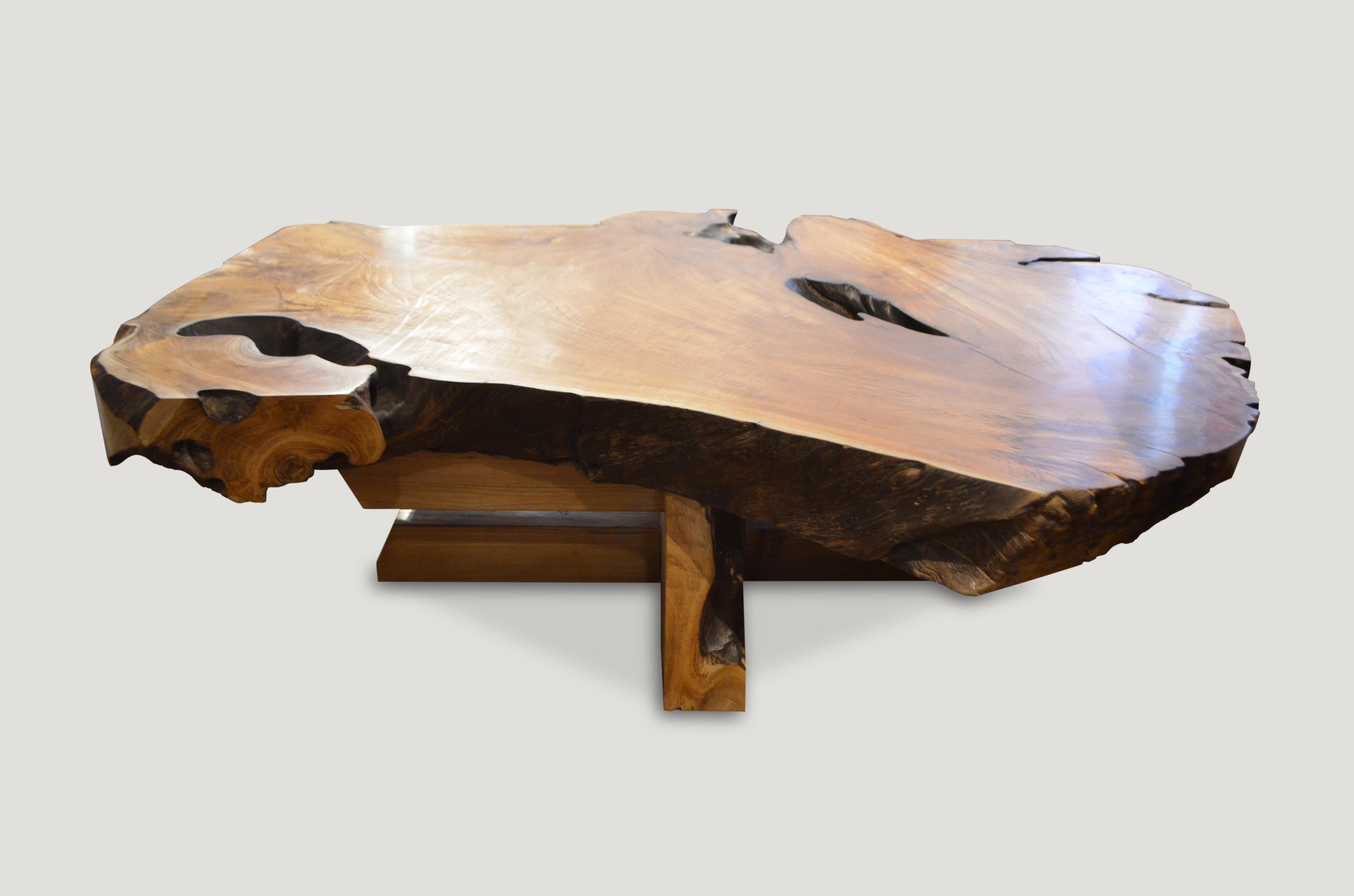 Impressive reclaimed teak wood single slab top coffee table. This beautiful 5” slab rests on a modern cross base and has a natural oil finish. We have charred the sides and inner crevices in contrast.

Andrianna Shamaris. The Leader In Modern