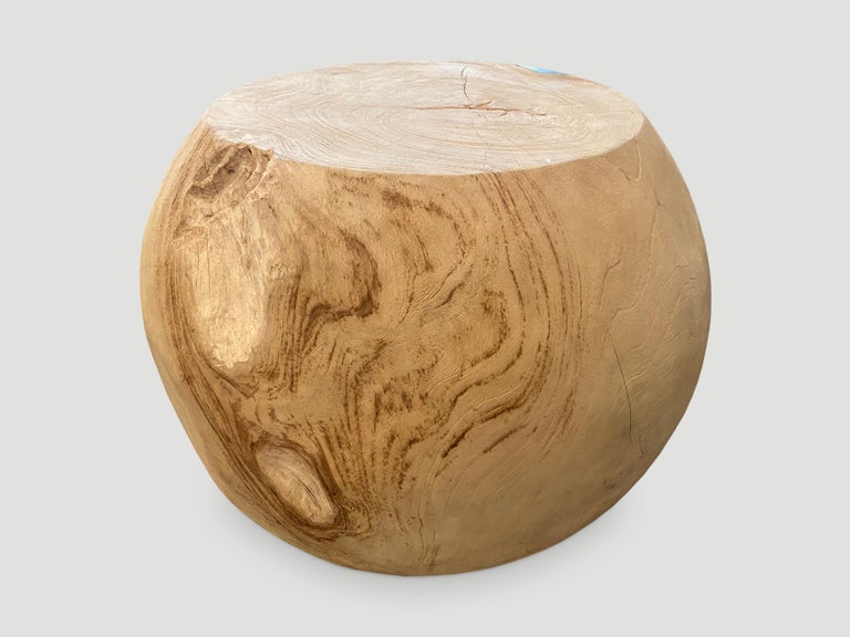 Beautiful side table hand carved into a drum shape. Pale blue resin is added into the natural organic groove of the reclaimed teak wood. We bleached the wood first revealing the beautiful wood grain. 22