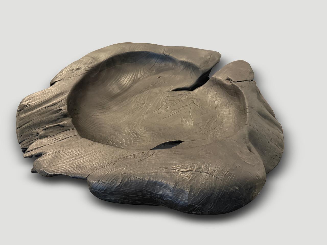Impressive large charred vessel hand carved from a single piece of reclaimed teak wood. Both usable and sculptural. Burnt sanded and sealed revealing the beautiful wood grain. It’s all in the details. 

The Triple Burnt Collection represents a
