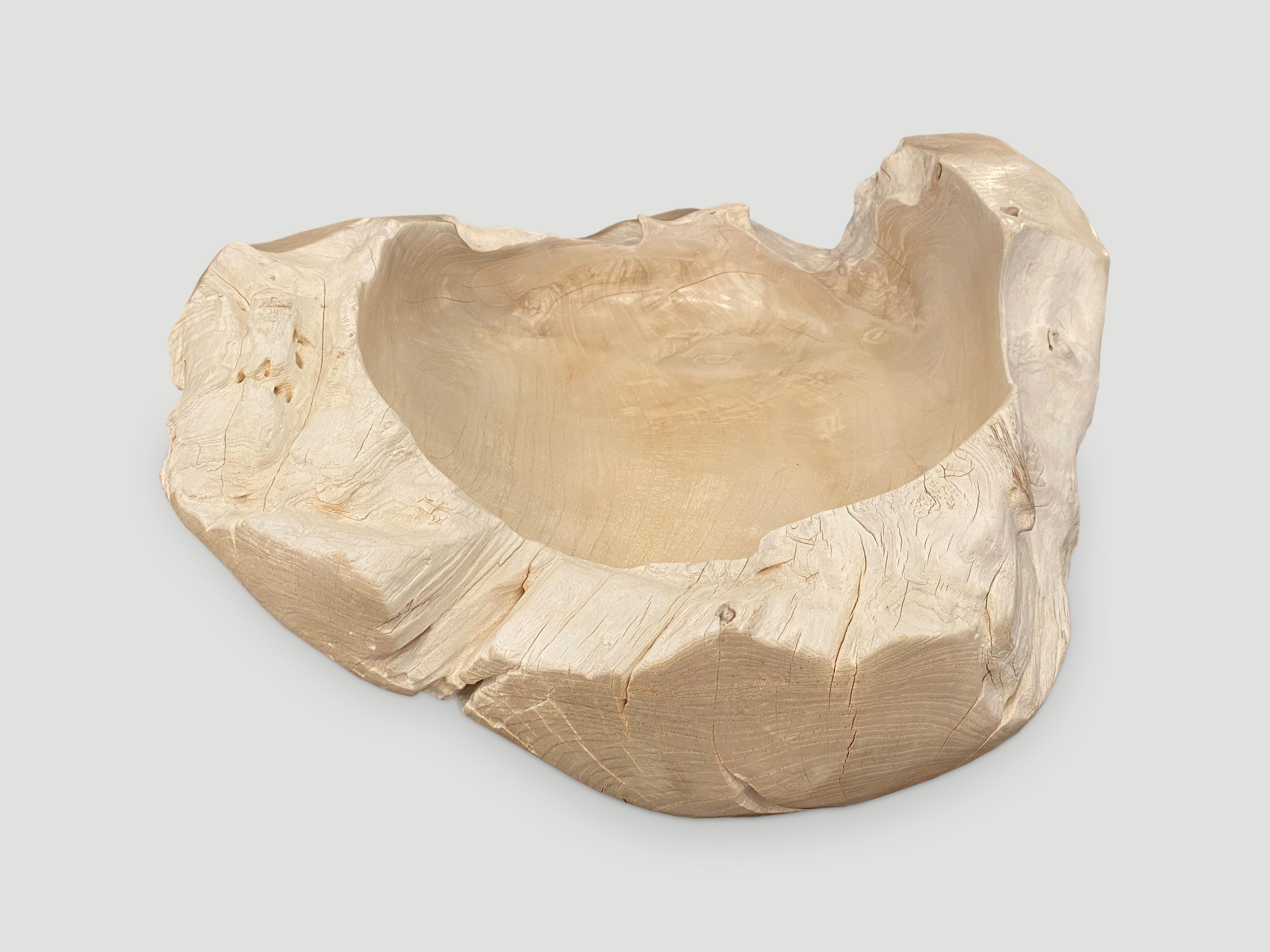 Impressive size on this reclaimed teak wood sculptural vessel. Great as an art object or useful to hold towels or magazines to name a few suggestions. Hand carved from a single piece of reclaimed teak wood and bleached with a smooth finish. We added