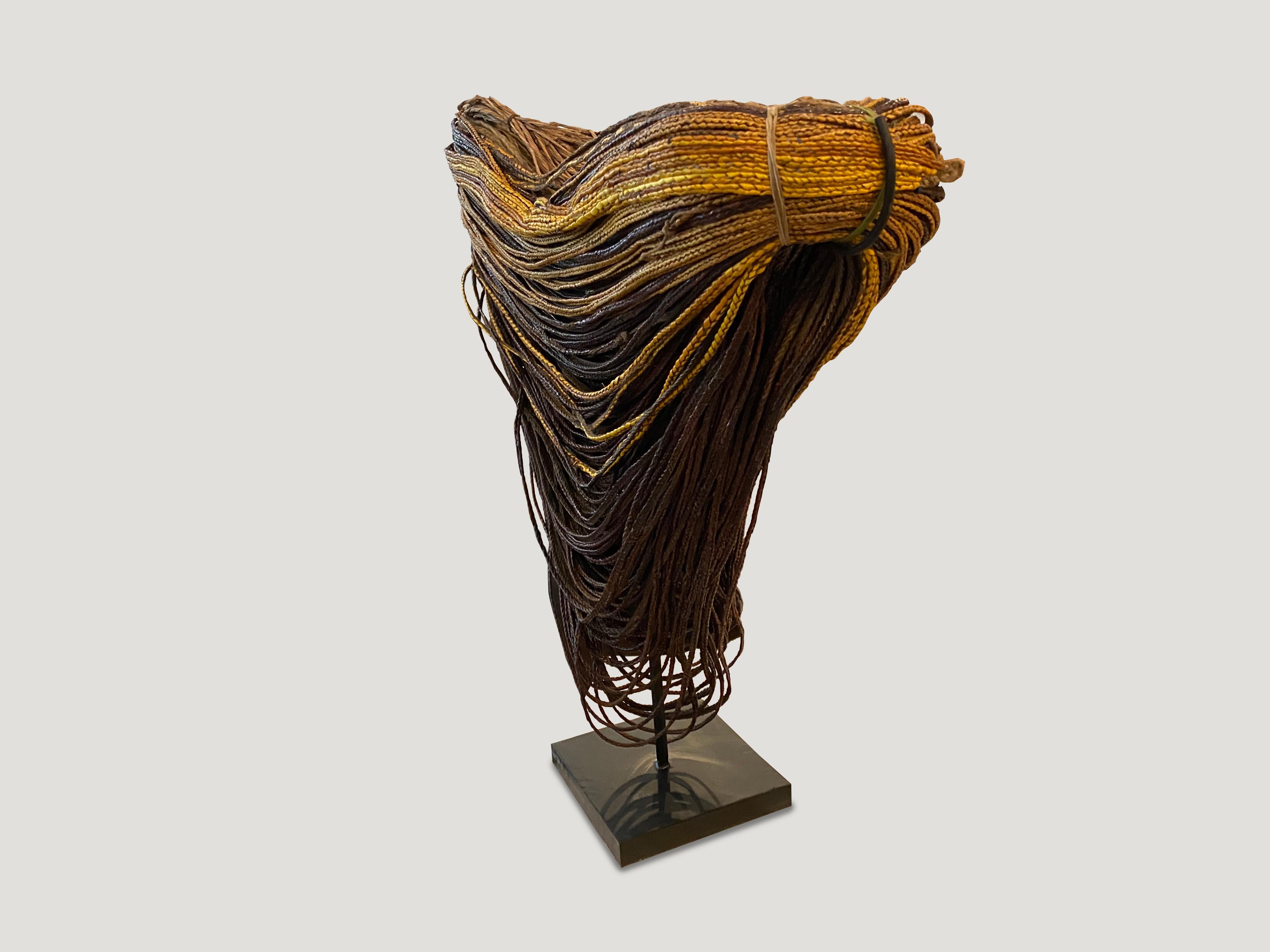 Antique skirt from Papua. Hand made from multiple lengths of yellow, brown, maroon and tan orchard bark. Set on a modern steel base. So beautiful.

This Papua skirt was sourced in the spirit of wabi-sabi, a Japanese philosophy that beauty can be