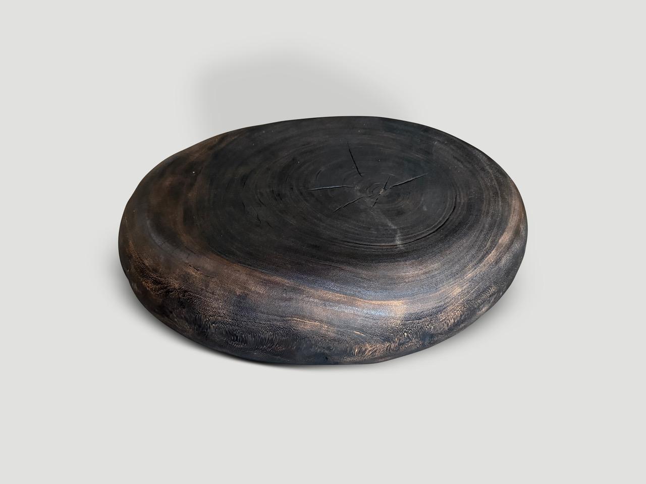 A minimalist pebble style low profile coffee table. Hand carved from a single piece of suar wood. Charred a rich brown revealing the unique wood grain. It’s all in the details. Full dimensions; Top 25” wide x 18” deep and the sides extend to 31”