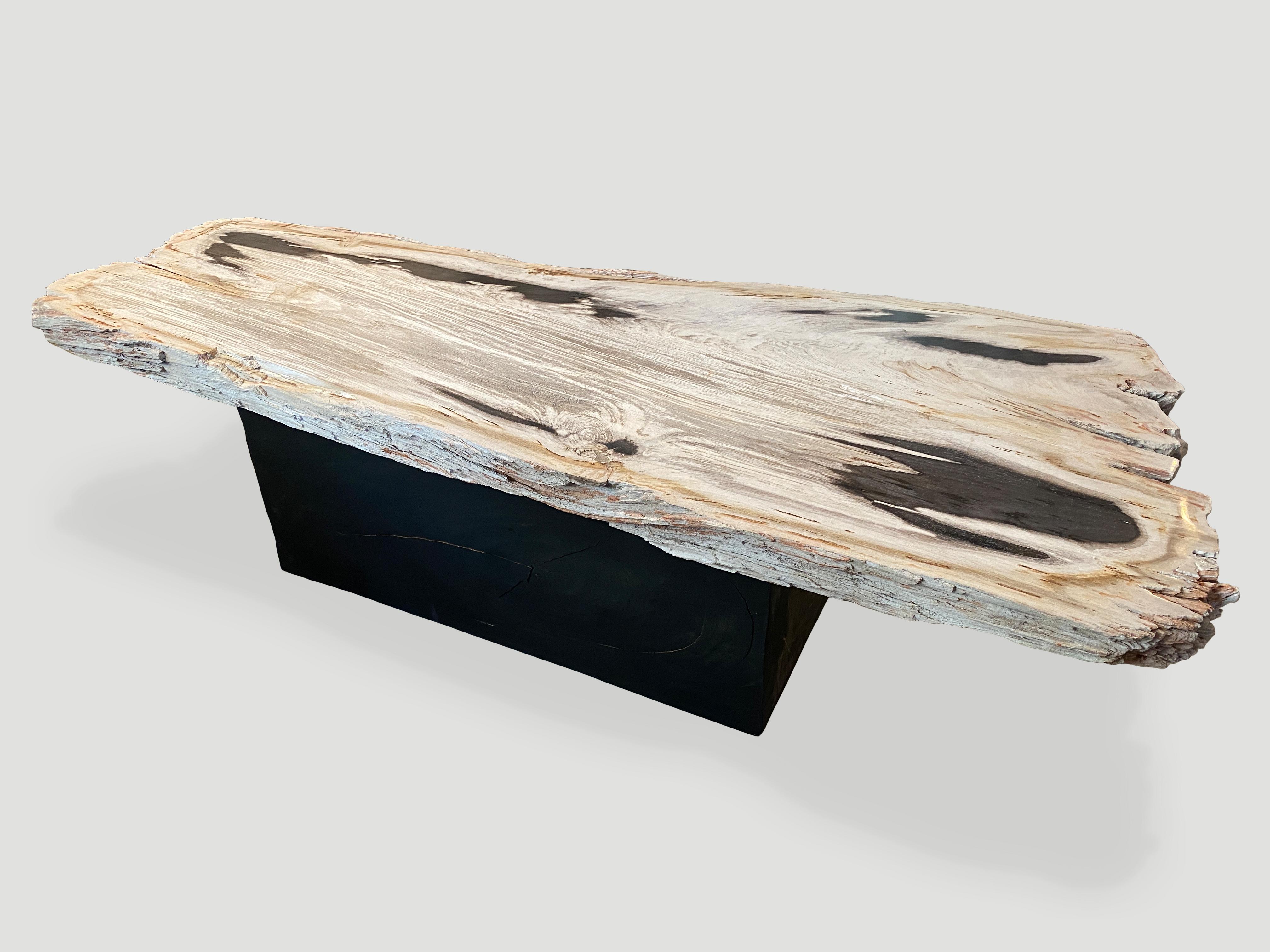 Impressive 2.5” single slab coffee table resting on a solid wood base. We can switch out the base for a console height. Please inquire. Bold contrasting black and white tones. It’s fascinating how Mother Nature produces these stunning 40 million