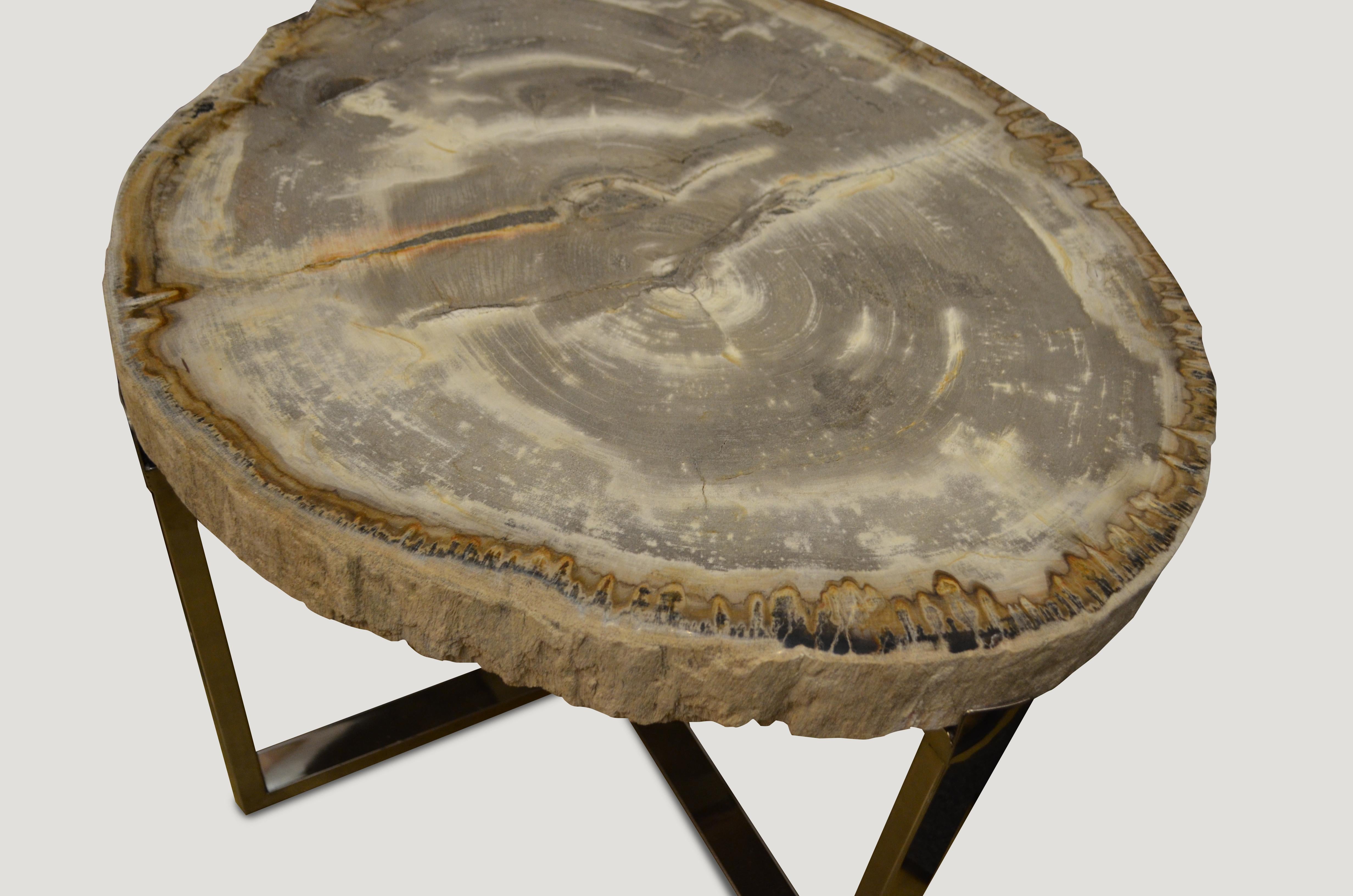 Rare, high quality petrified wood 3? slab top side table. Stunning grey and white tones with visible crystals. Set on a modern stainless steel base. Pair available. The price reflects one.

We source the highest quality petrified wood available.