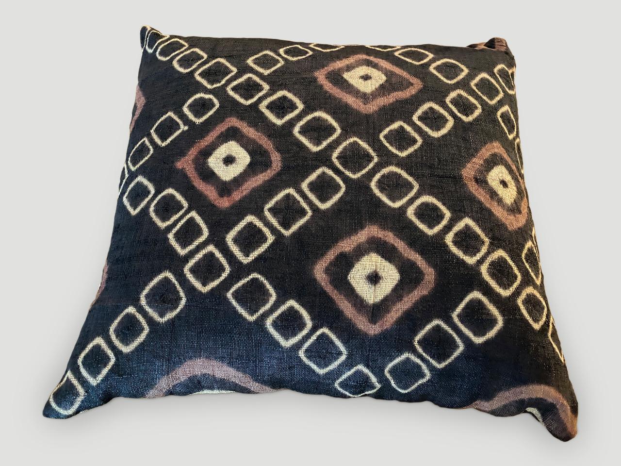 Striking double backed African resist dye raffia pillow made from a vintage textile. Geometric design in shades of brown, orange and natural. Concealed zipper and inserts included. Circa 1950.

Andrianna Shamaris. The Leader In Modern Organic