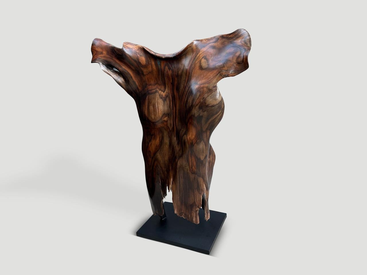 Impressive century year old wood with incredible patina and character is set on a minimalist black steel base. This beautiful single piece of wood has been hand carved whilst respecting the natural organic shape. It’s all in the details. Full