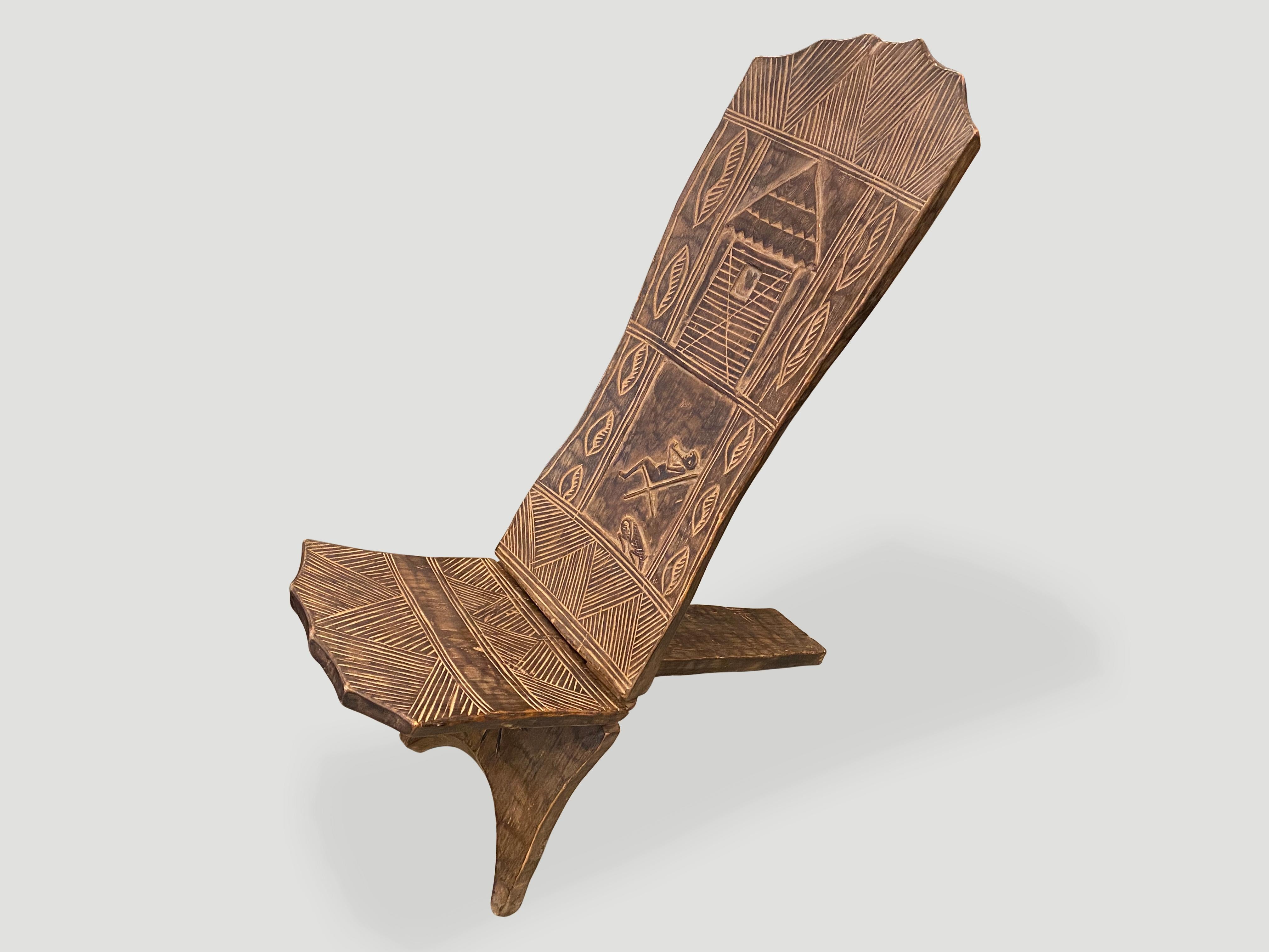 Rare antique African hand carved chair. Beautiful patina on the single wood back rest, with multiple motifs. This folding chair is made from a single piece of ébéniste wood from west Africa. Also called guard chair, the palaver chair is a