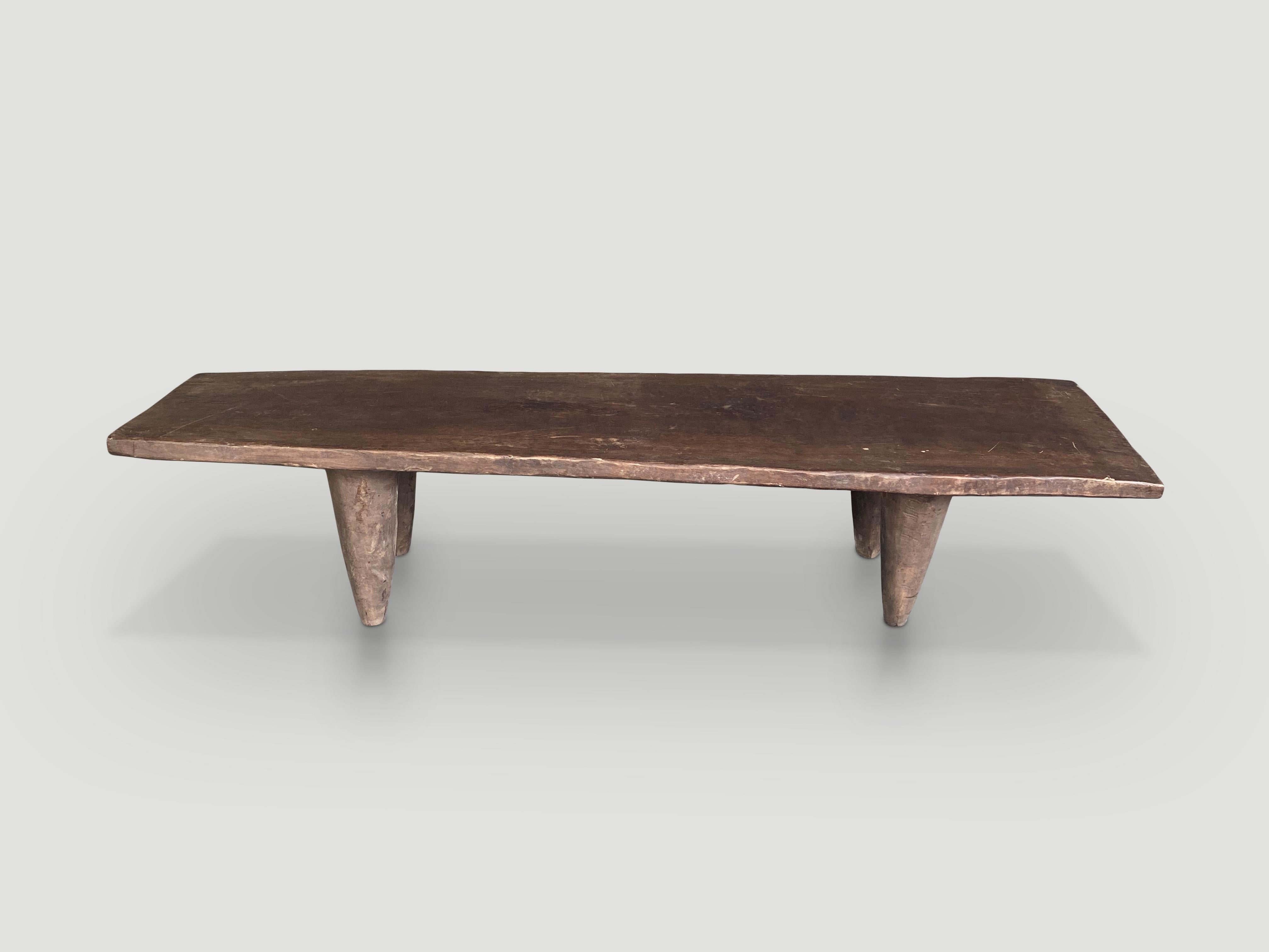 Rare antique coffee table hand carved by the Senufo tribes from a single block of Iroko wood, native to the west coast of Africa. The wood is tough, dense and very durable. Shown with carved cone style legs. We only source the best. This one is