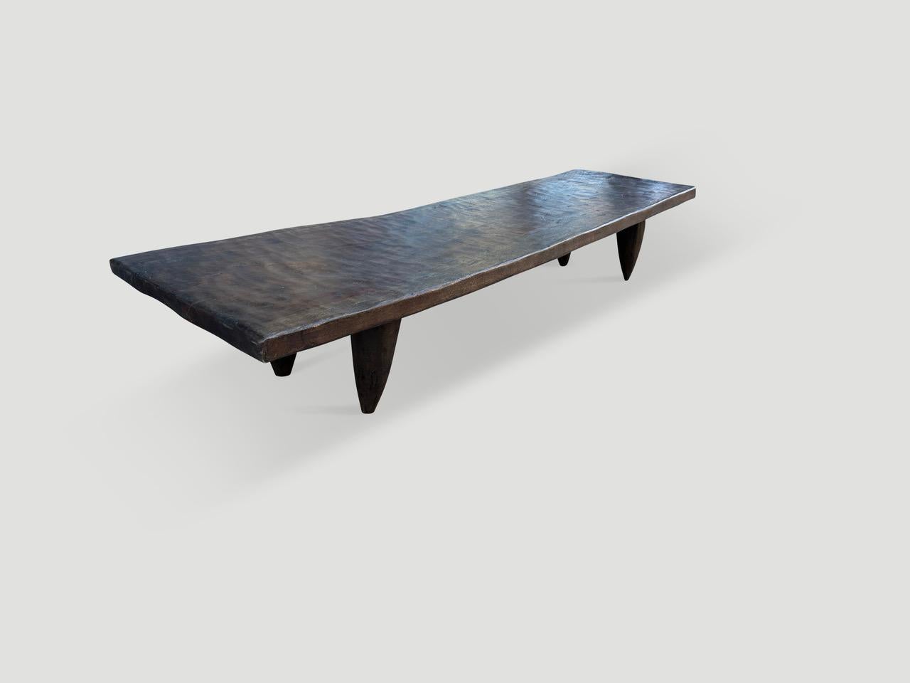 Rare antique coffee table hand carved by the Senufo tribes from a single block of Iroko wood, native to the west coast of Africa. The wood is tough, dense and very durable. Shown with carved cone style legs. We only source the best. This one is