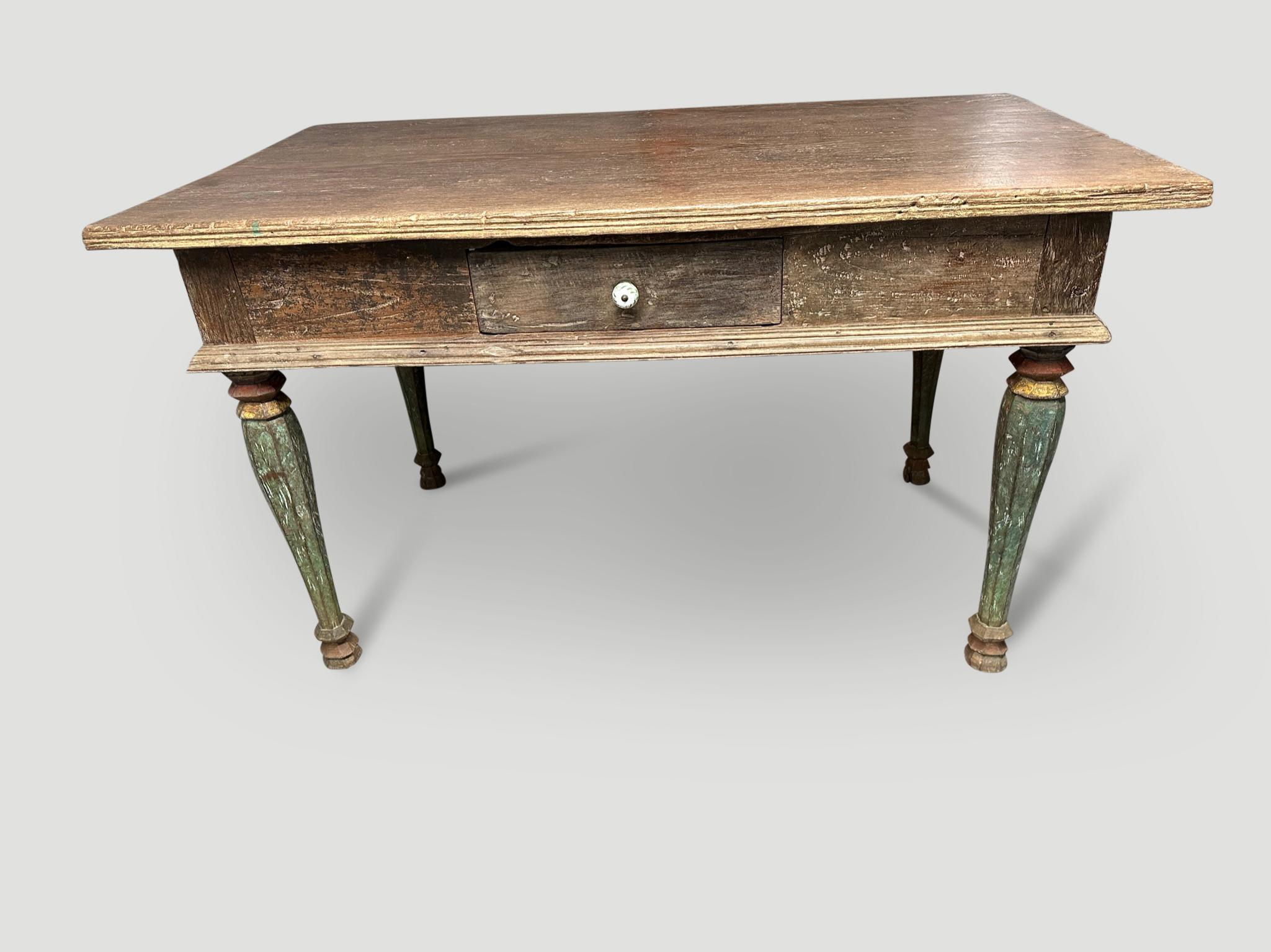 Antique colonial desk or console. The patina on this teak wood is beautiful. Hand carved legs with the original remnants of color and beautiful carving around the side, make this a special piece. This desk or console has been restored to its