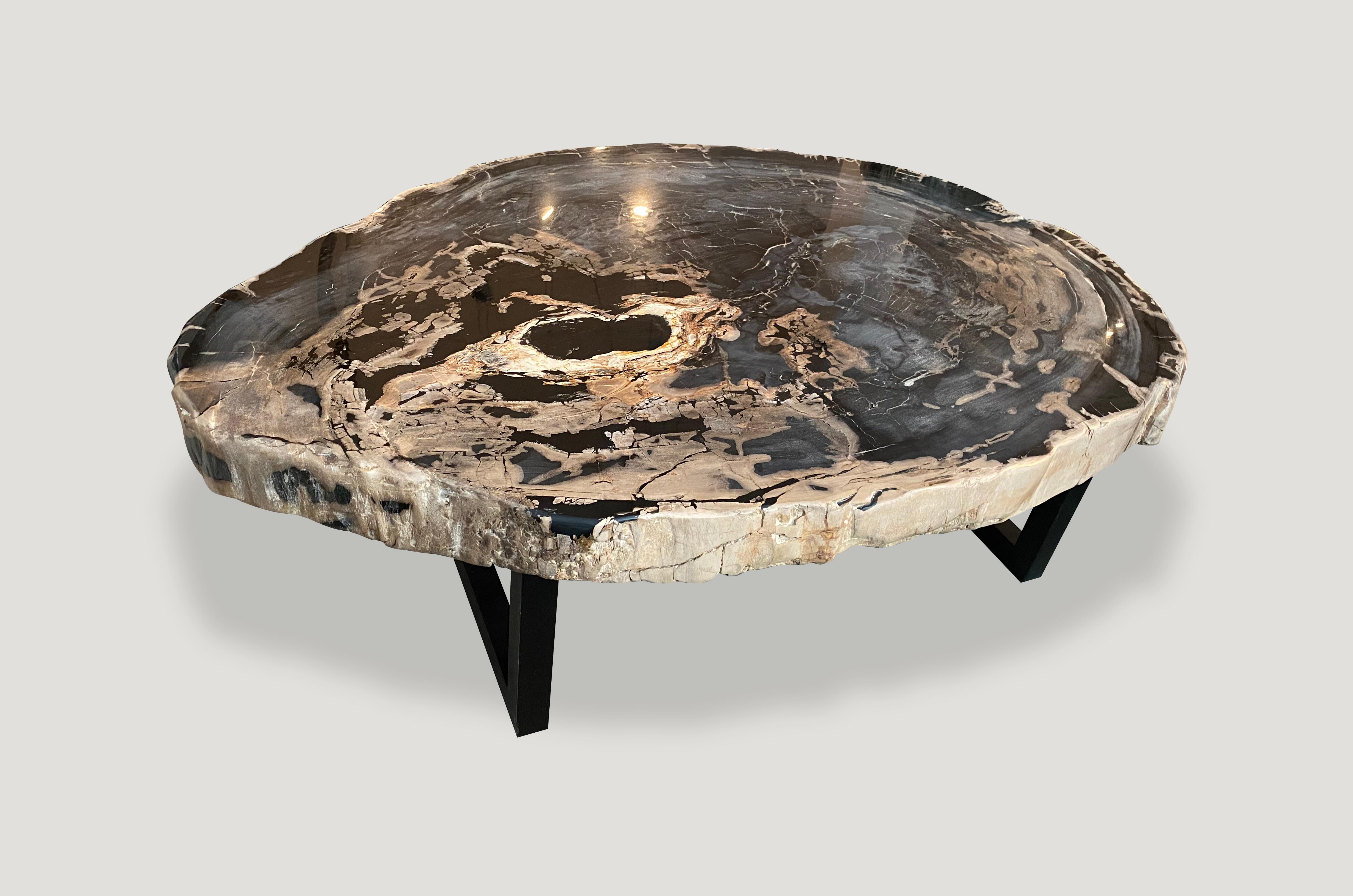 It’s rare to find these black, grey and camel tones in a petrified log. We have a pair cut from the same petrified log. Both super smooth and high quality. Shown with a black metal base. The price reflects one.

As with a diamond, we polish the