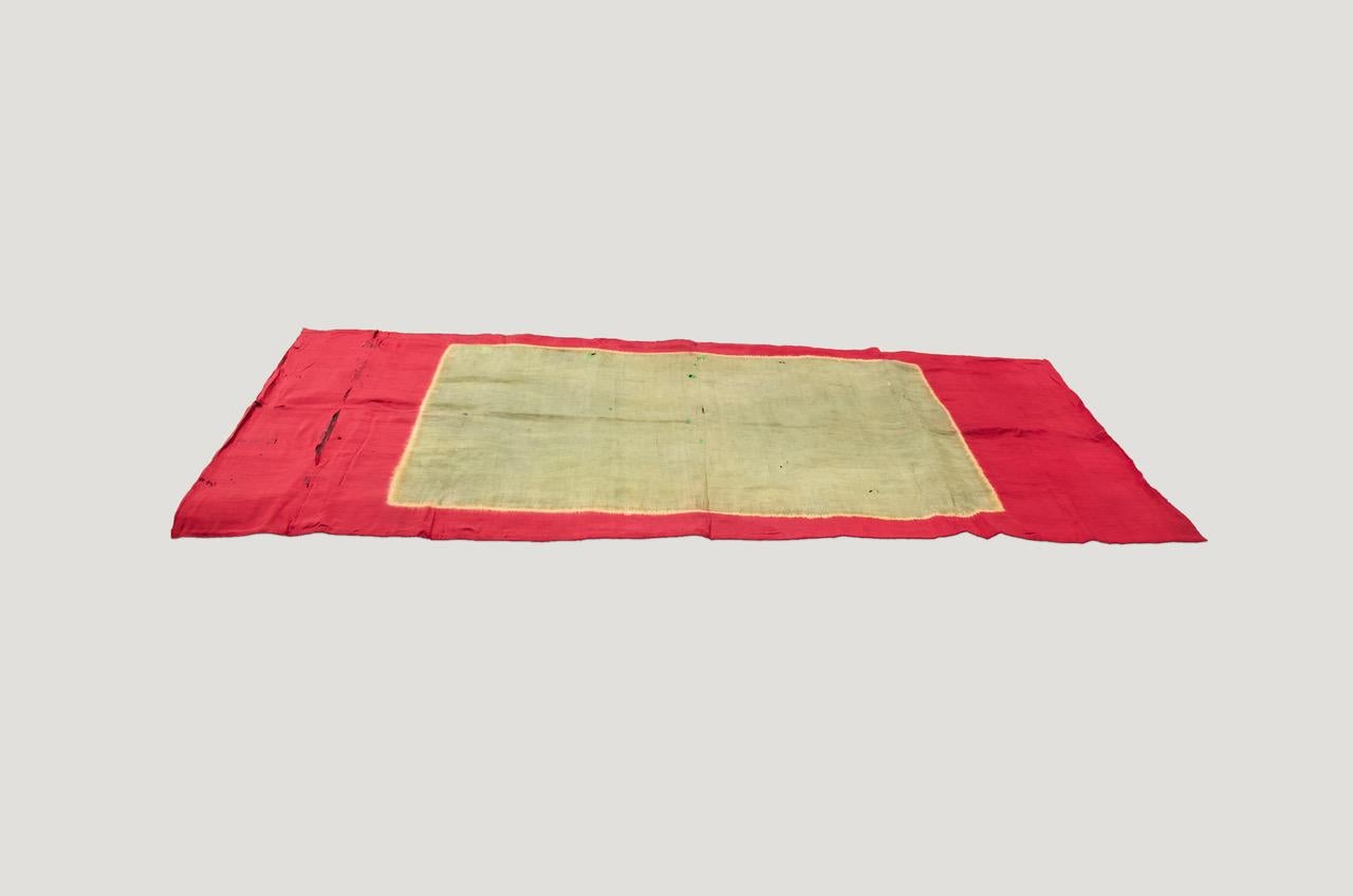 This graphic and minimalist Indonesian silk ceremonial shawl, is mounted as a textile art wall hanging and backed onto a black canvas. Lawon textiles became popular in the West during the modernist art movement due to their resemblance to the