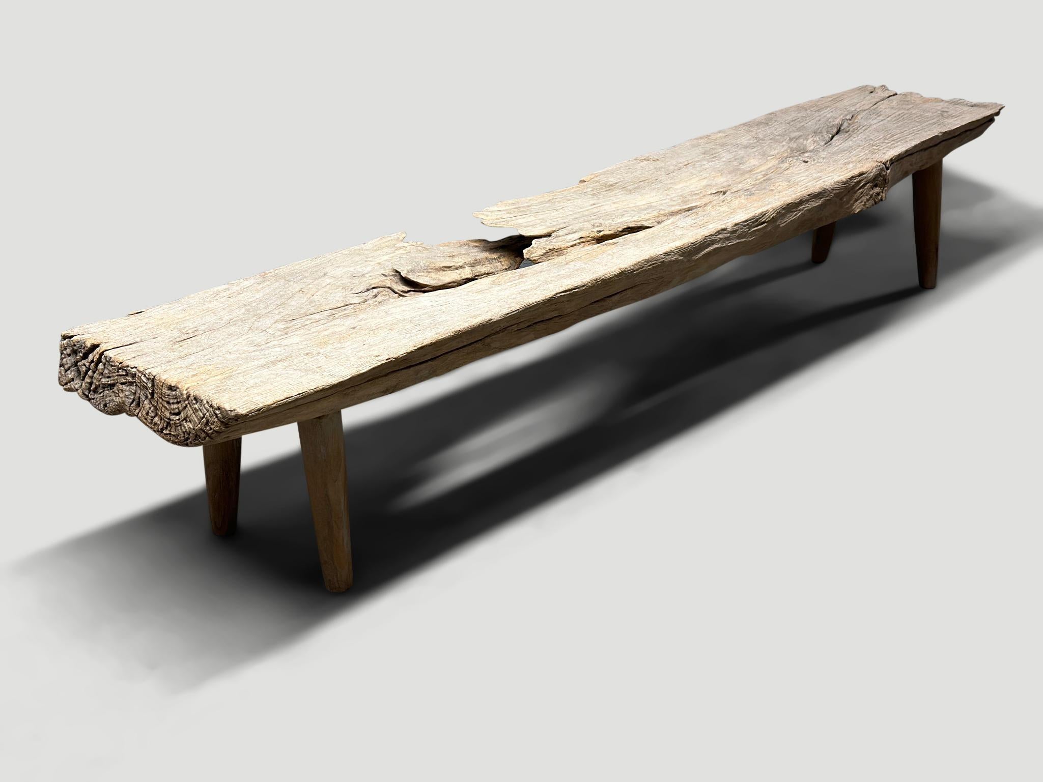 Impressive three inch thick teak bench. Beautiful details in this 100 year old wood. We added minimalist cone style legs. Both usable and a piece of art. Rare.

This bench was hand made in the spirit of Wabi-Sabi, a Japanese philosophy that beauty