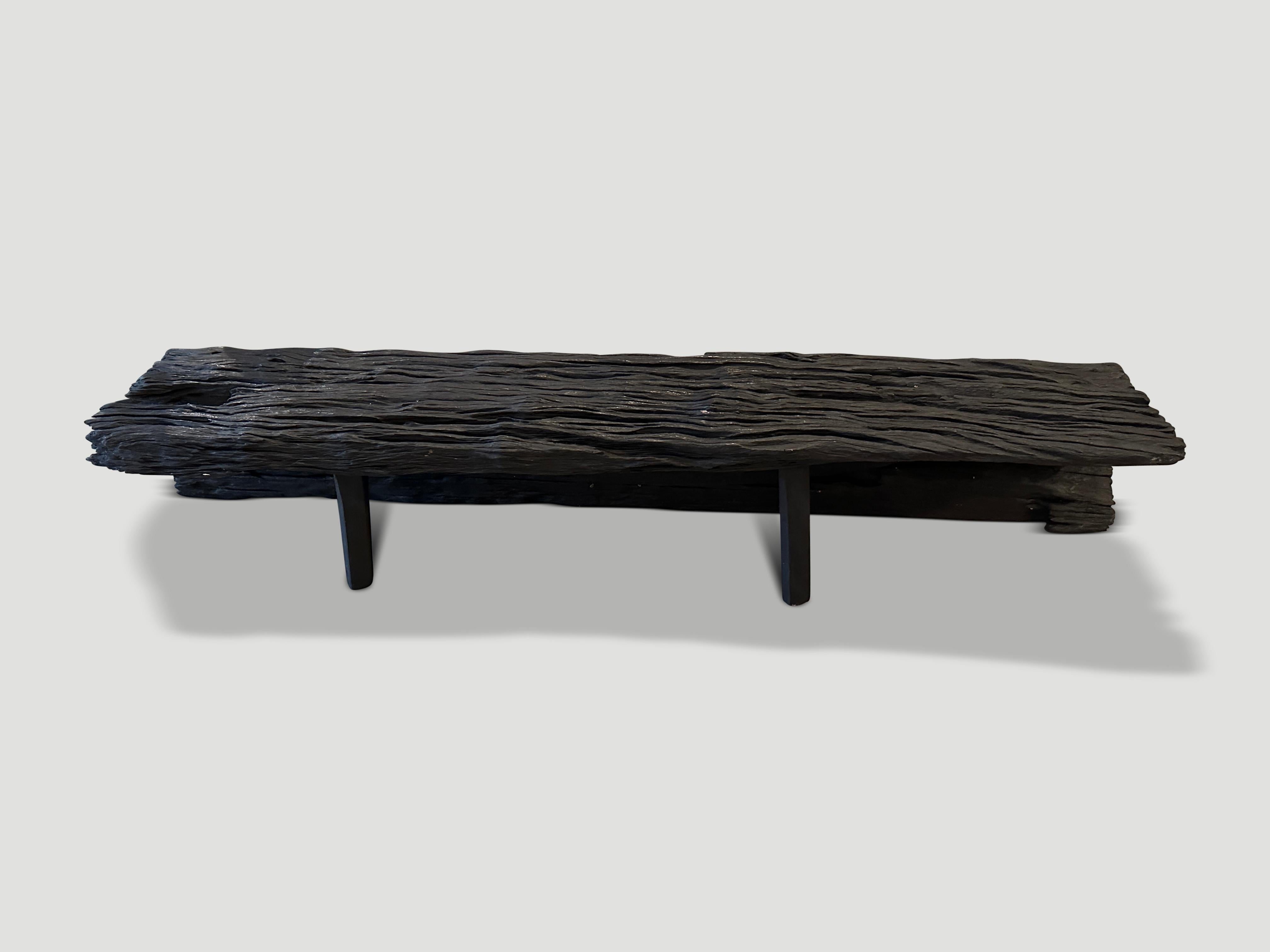 Beautiful iron wood long bench, both sculptural and functional. Charred, sanded and sealed revealing the stunning detail in this century old wood. One of a kind piece from a single curved section. We added the minimalist legs to one side. It’s all