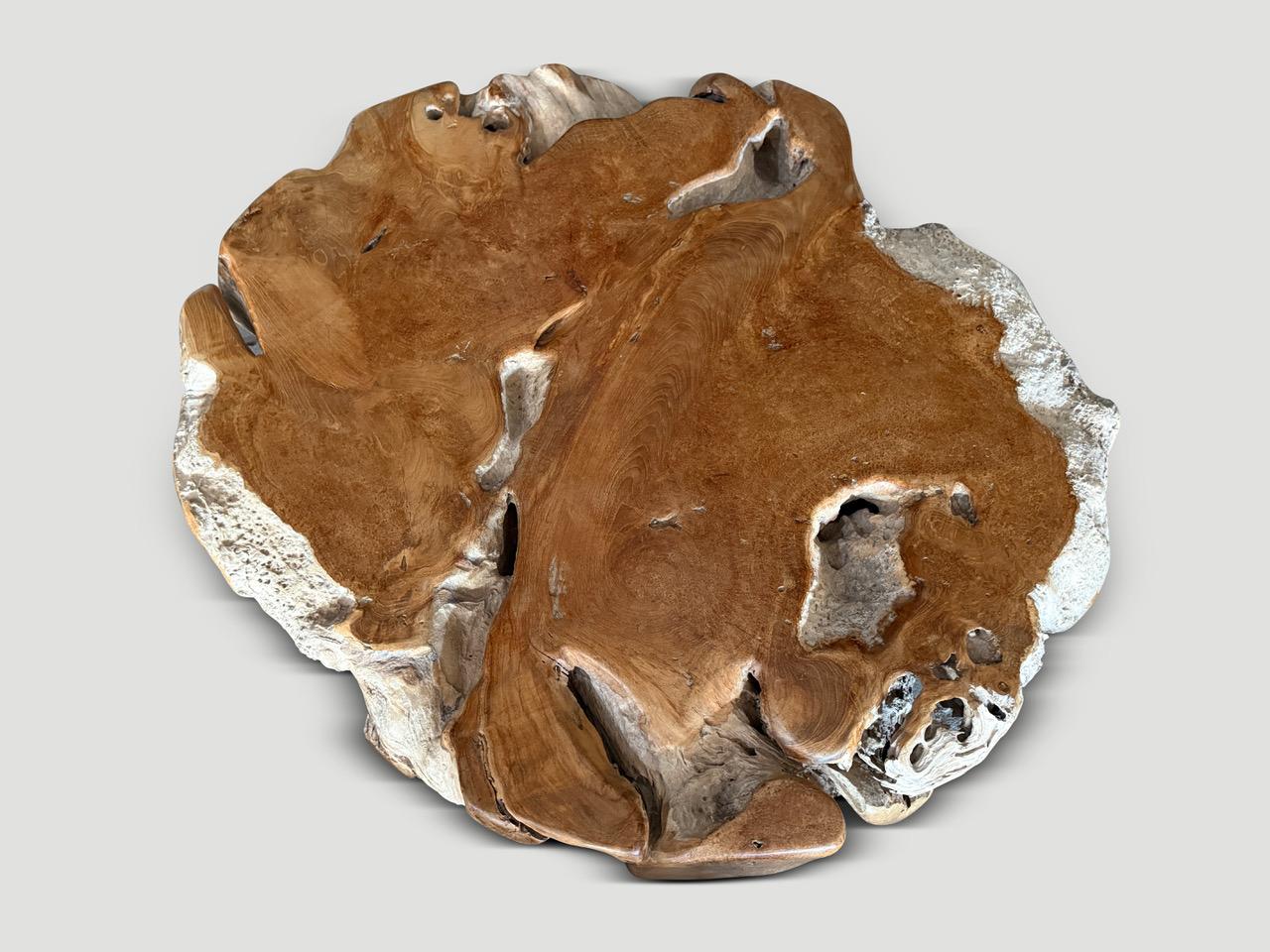 Rare century old teak wood polished on the flat sections whilst leaving the more organic sides pure in contrast. This ancient wood is unique. The organic shape is repurposed into an impressive one of a kind coffee table. Finished with a natural oil