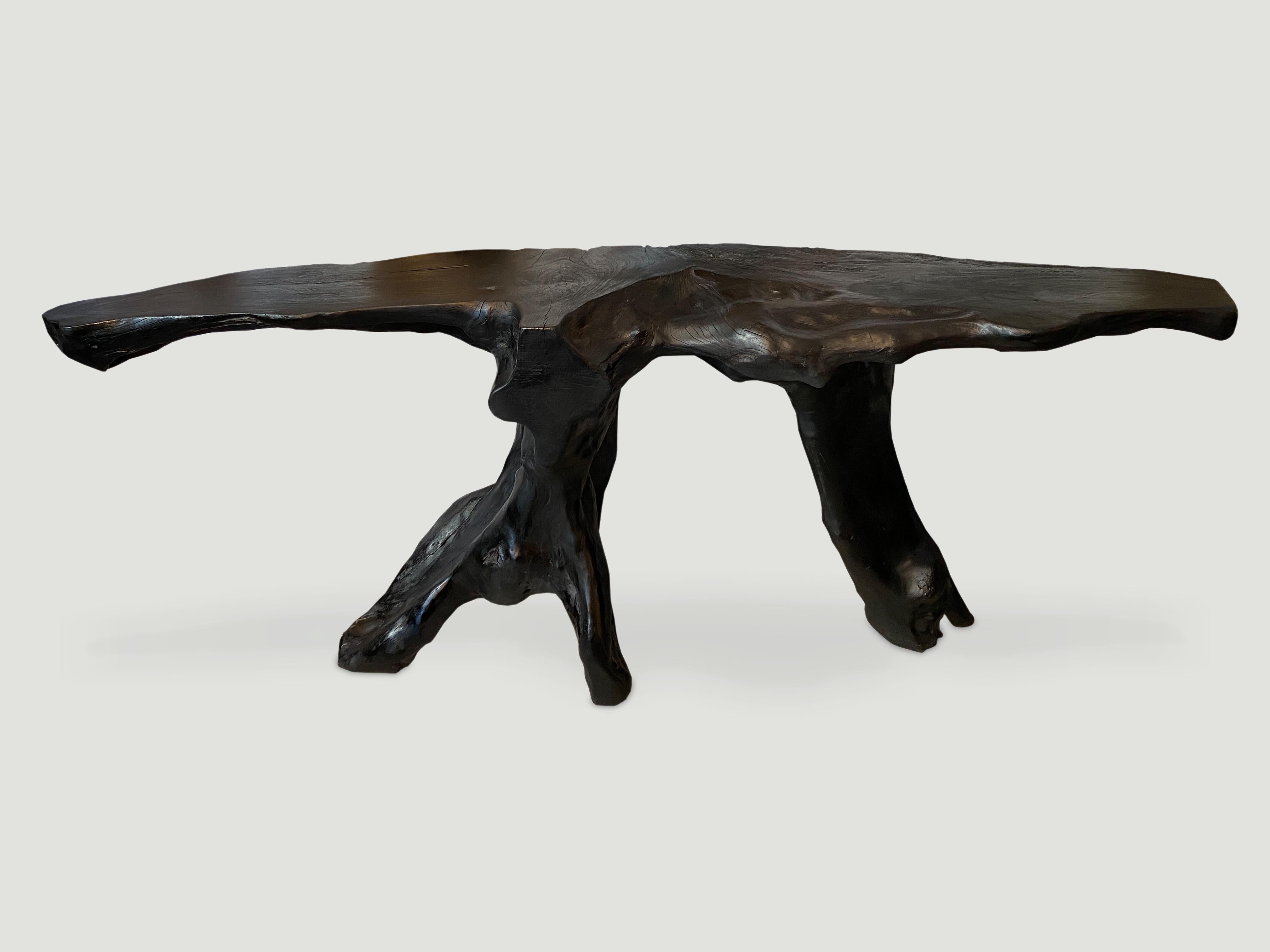 Impressive reclaimed single teak wood root console table charred black. Stunning on both sides. Functions as a console or a piece of art.

The Triple Burnt Collection represents a unique line of modern furniture made from solid organic wood. Burnt