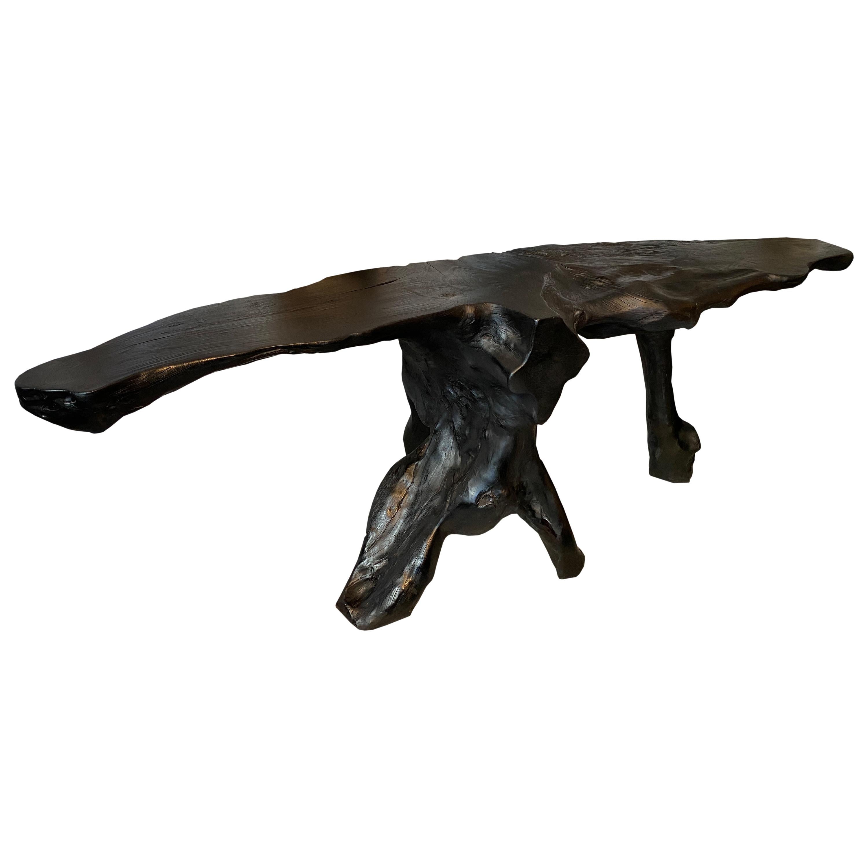 Impressive reclaimed single teak wood root console table charred black. Stunning on both sides. Functions as a console or a piece of art.

The Triple Burnt Collection represents a unique line of modern furniture made from solid organic wood. Burnt